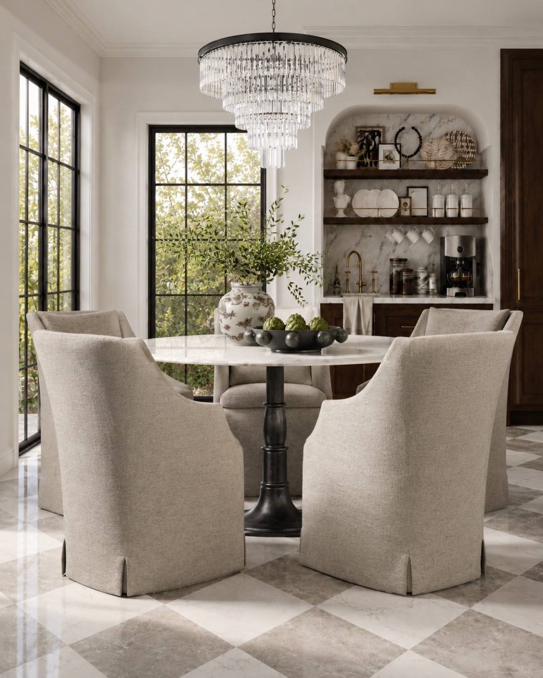 This dining corner has that timeless European kitchen feel: skirted upholstered chairs, a round marble table, black pedestal base, checkerboard stone floors, dark wood cabinetry, marble backsplash, open shelves, brass accents, and a statement chandelier. It’s elegant, warm, and still practical for everyday dining.
I may receive a commission when you shop through my links.

#LTKHome