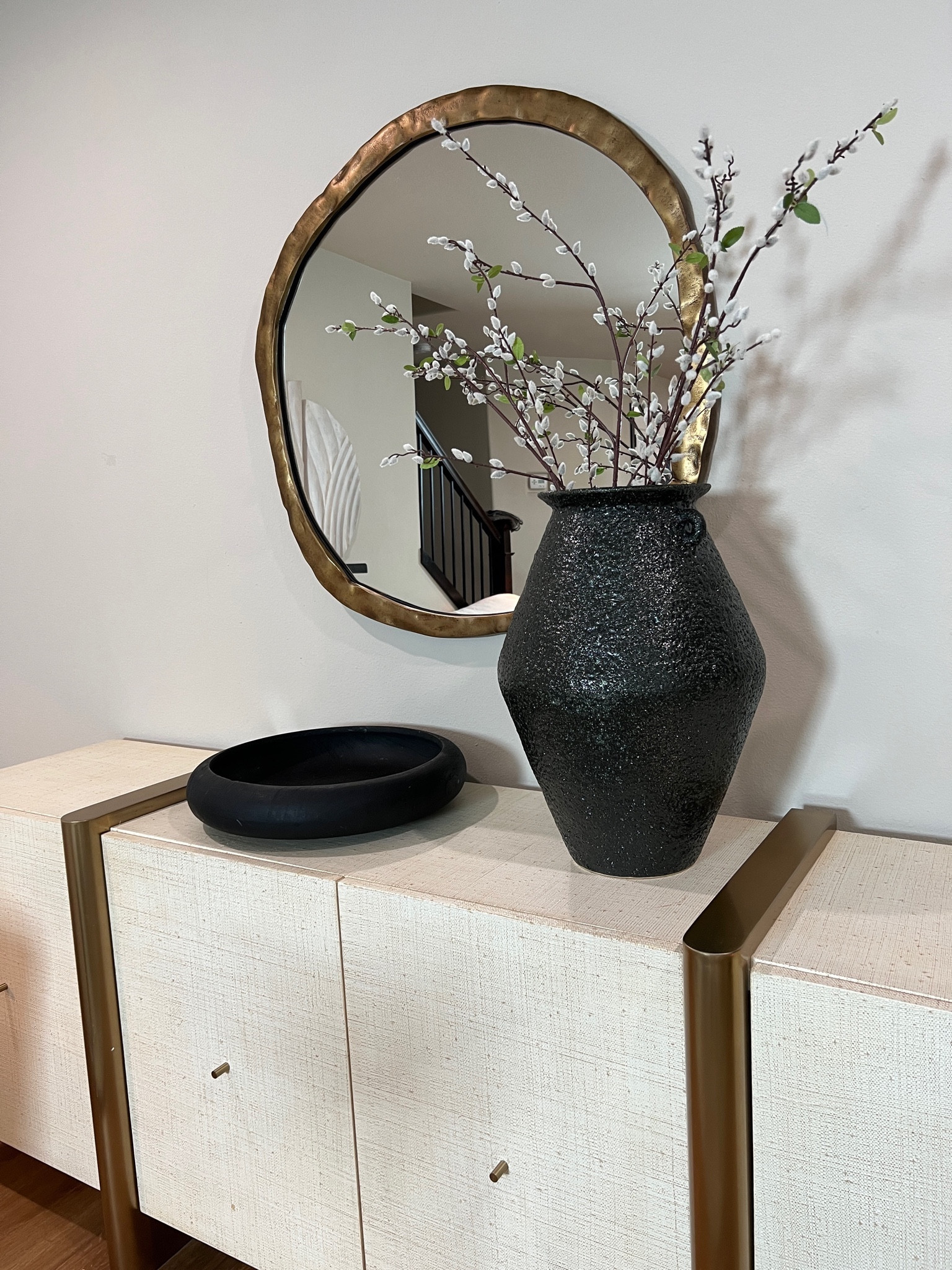 Media console styling 
My 2024 living room decor decor video is up on YouTube now check it out (search lovely at home ) 
Wall mirror, black bowl, large vase, living room decor, Home decor 2024, crate and barrel 

#LTKhome #LTKstyletip