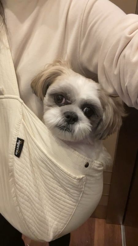 This carrier always gets a lot of compliments. Comfortable petite friendly pet sling. Ralphie is a 15 pound Shih Tzu. The wider non-adjustable strap is comfortable. I would say 15 pounds is about the maximum this carrier can hold. I'm 5' 2.5" and 115 pounds. 

Dog wearing sling gift idea 

#LTKbaby #LTKHoliday #LTKGiftGuide