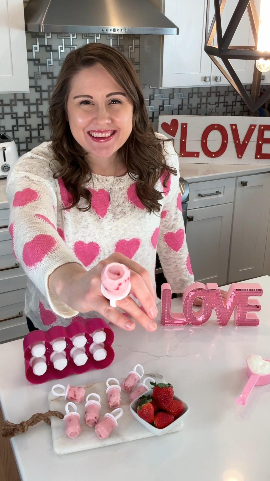 These Frozen Yogurt ring pops made with fresh fruit are a fun, healthy Valentine’s Day Treat!  I used my mini food processor to puree 4 large strawberries, added in 1/2 cup of vanilla flavored Greek yogurt and little bit of honey.  Mix in chopped strawberries and pour into your ring pop molds.  Let freeze and you’ve got the cutest healthy treat for V-Day! #valentinesdaytreats #healthyvalentinesdaytreat #healthyrecipe

#LTKfamily #LTKhome #LTKSeasonal