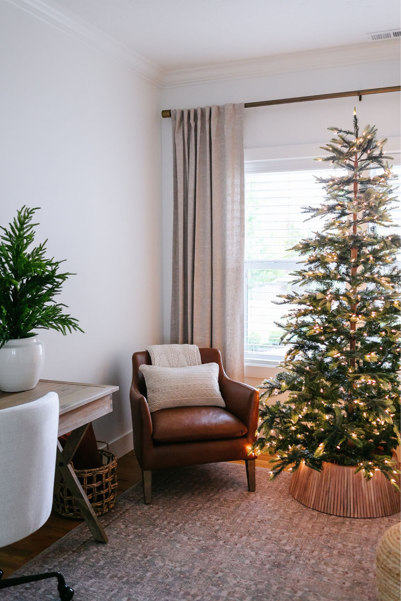 Christmas decor, holiday decor, faux trees, bookshelf decor, wreath, artwork, Pottery Barn leather chairs, faux Christmas tree, Pottery Barn drapes, living room, Loloi area rug 

#LTKhome #LTKHoliday #LTKSeasonal