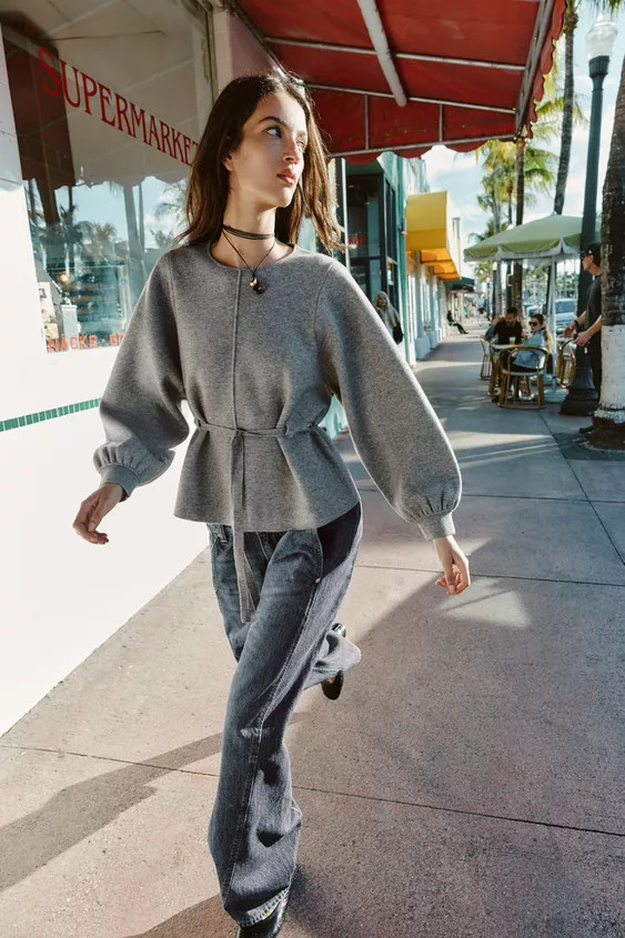 Round neck jumper with long puff sleeves and cuffed wrists. Features a pronounced front seam. Adj... | Zara US