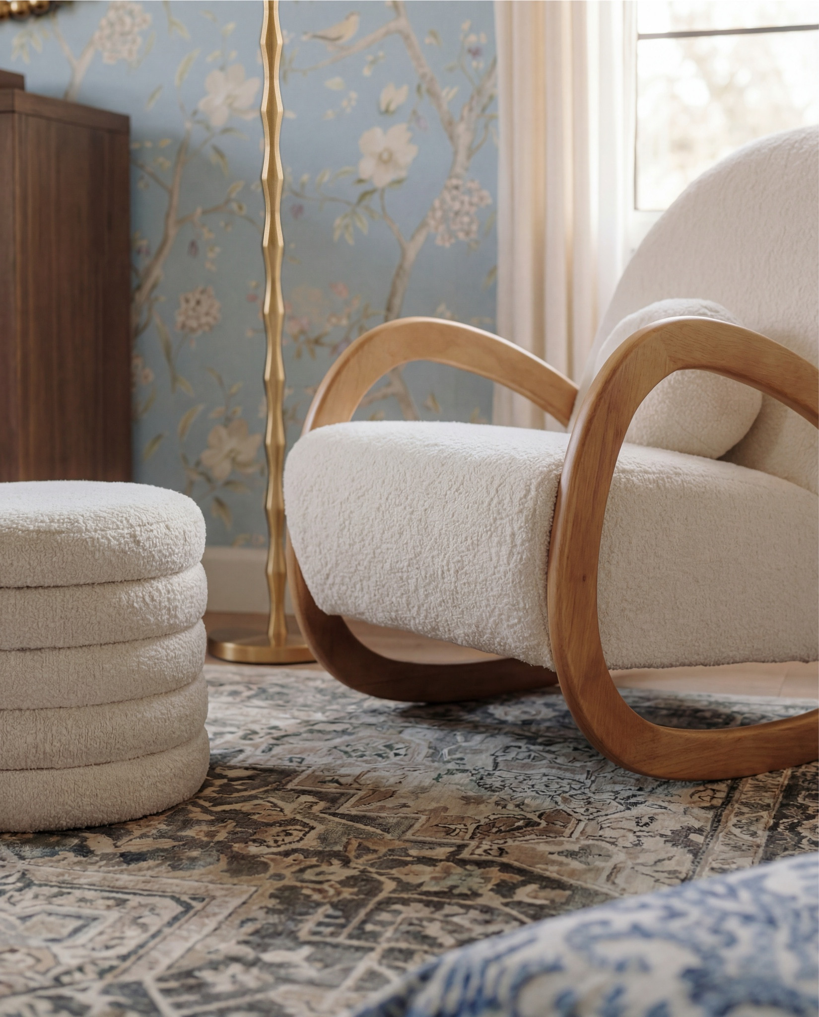 Shop the Look:
• Light blue floral wallpaper
• Natural wood exposed ceiling beams
• Solid wood crib (warm oak tone)
• Neutral crib mattress + fitted sheet
• Knit baby blanket (soft brown)
• Vintage-inspired area rug (muted blue + beige)
• Wood dresser with woven drawer fronts
• Round gold-framed wall mirror
• Brass table lamp with white shade
• White boucle accent chair
• Round upholstered pouf (cream)
• Wooden toy shelving unit
• Front-facing wooden book rack
• Children’s board books (colorful covers)
• Plush teddy bear
• Soft cloud wall decor
• Star-shaped wall pillows (neutral tones)
• Crescent moon wall decor
• Beaded rainbow toy
• Sheer white curtain panels
• Black curtain rod with rings
• Light wood flooring

#LTKHome #LTKSaleAlert #LTKFindsUnder100