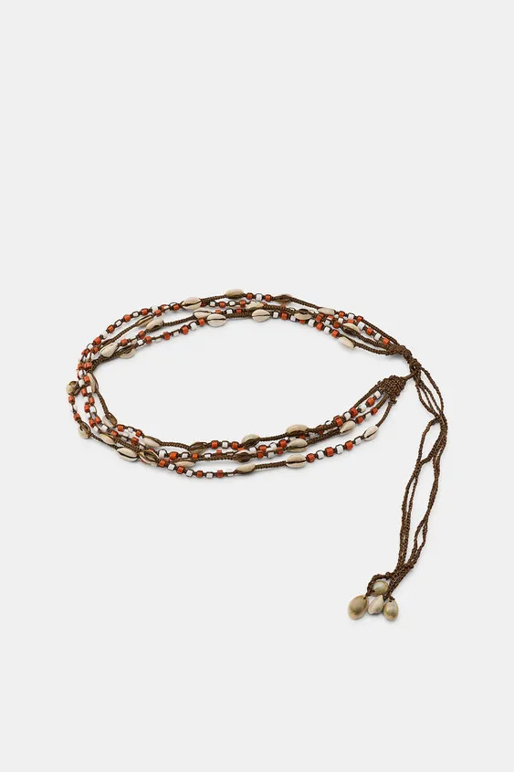 Combined belt with multiple cords and knots. Featuring natural shells and bead appliqu\u00e9s. Ad... | Zara US