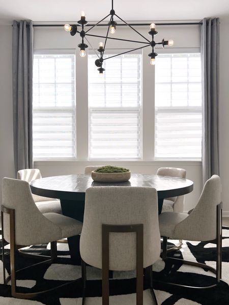 Modern Dining Room Inspo

Cream and brass dining chairs, black chandelier, gray curtains

#LTKhome #LTKstyletip #LTKover40