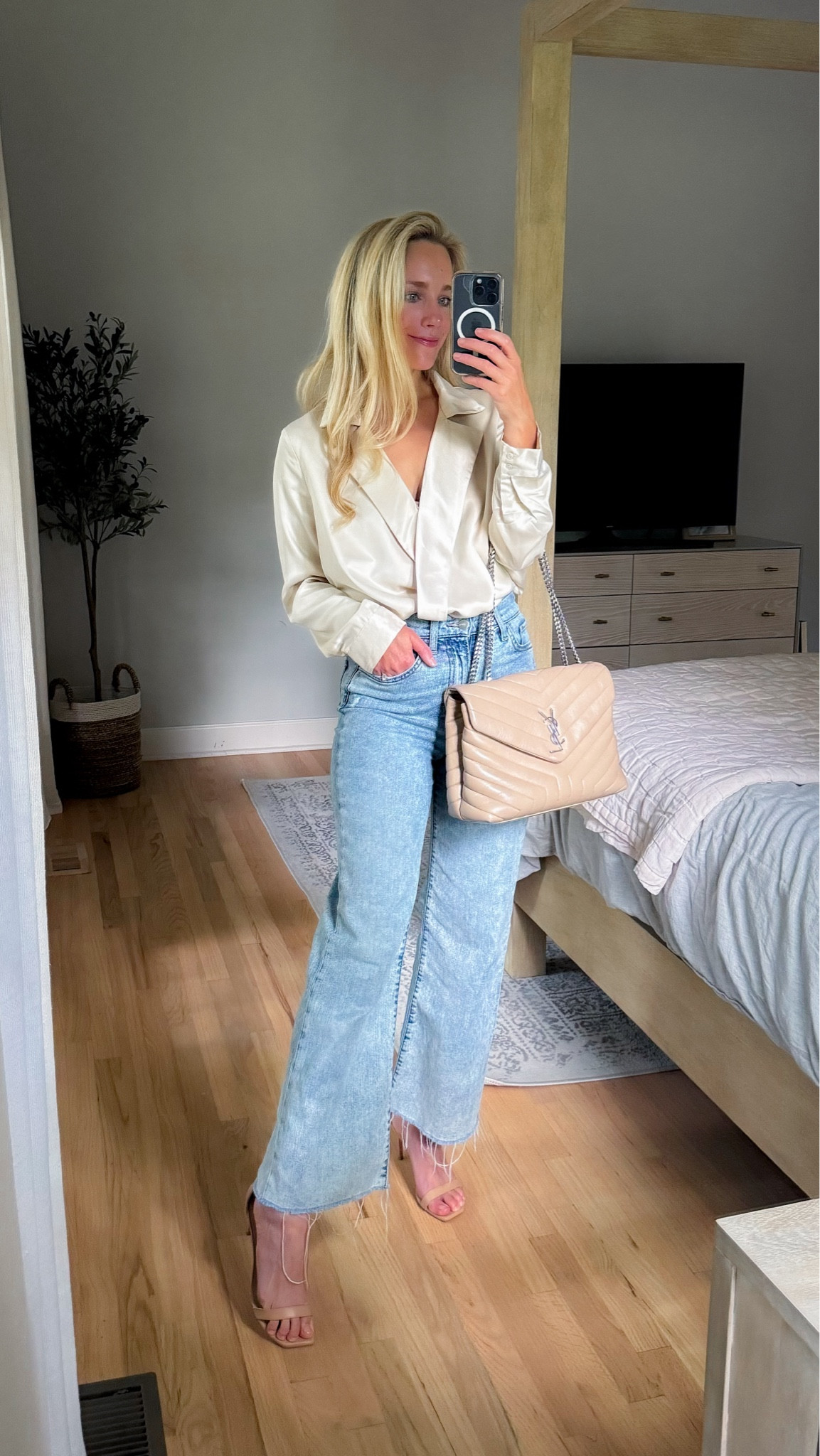 Love this long sleeve satin blouse, wrap shirt, ivory blouse, neutral blouse, cream top, workwear date night outfit office outfit endless rose, wide leg, jeans, Joe jeans light wash denim YSL bag quilted bag neutral bag designer bag Stuart Weitzman sandals neutral heels 

#LTKWorkwear #LTKSummerSales #LTKFindsUnder100