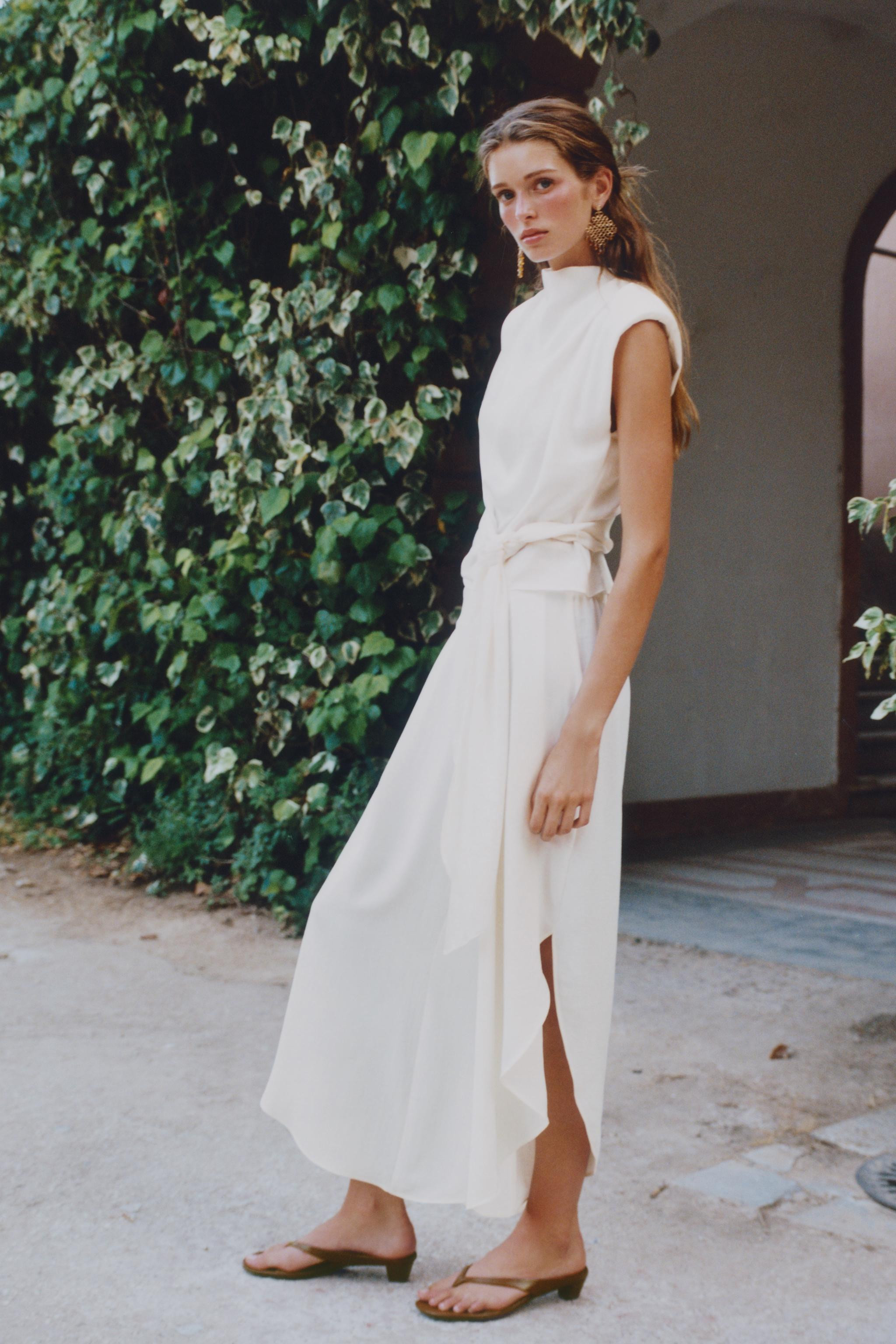 High neck sleeveless top with shoulder pads and pleats. Knot at hem. Back opening with hidden but... | Zara US
