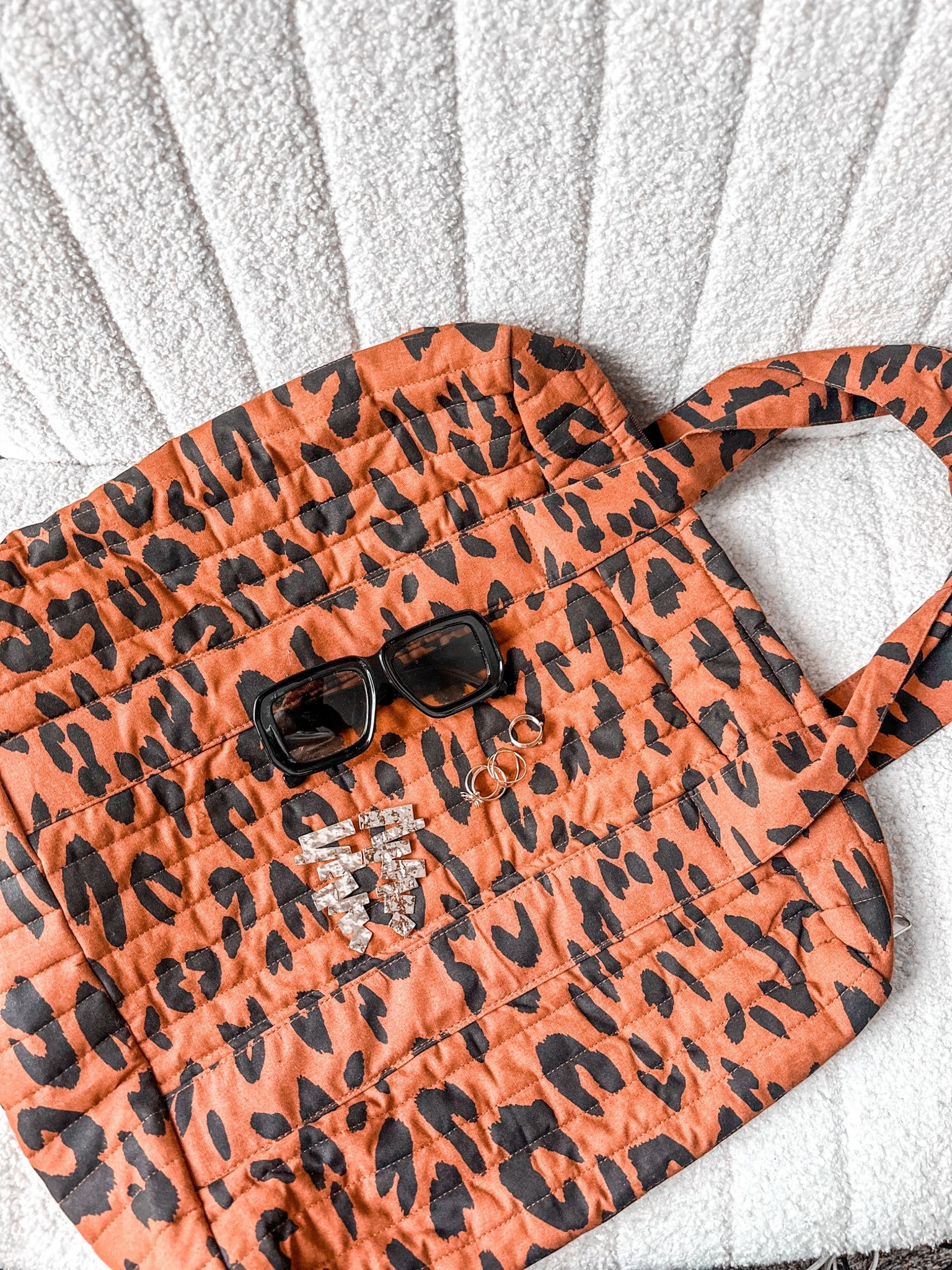 Effortless little details that make the outfit hit. 🐆🖤
This quilted tote has been my everyday grab + go lately — lightweight, holds everything, and gives that “I’m put together” vibe without even trying. Paired with my go-to sunnies and chunky gold hoops for that soft-luxe finish.
Shop the look👇🏽
#LTKfashion #LTKunder50 #fallstyle #momstyle #ootd 

#LTKGiftGuide #LTKFindsUnder100 #LTKItBag