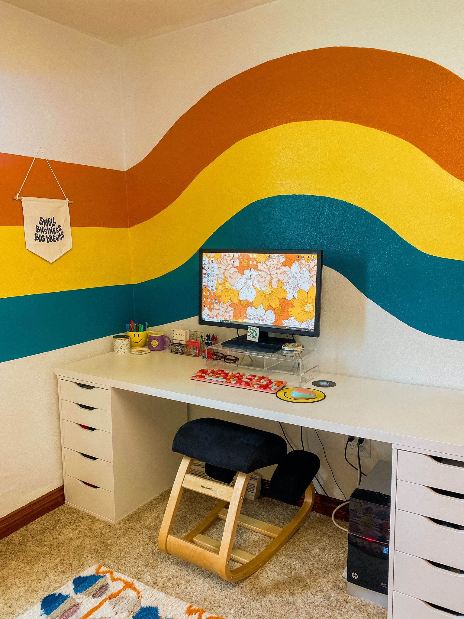 My groovy office 🪩🧡 ergonomic kneeling chair / office chair / computer monitor stand / typewriter keyboard / smiley face / retro / 70s / record coasters / small business office / home office / ikea desk / ikea Alex drawer unit 

#LTKHome