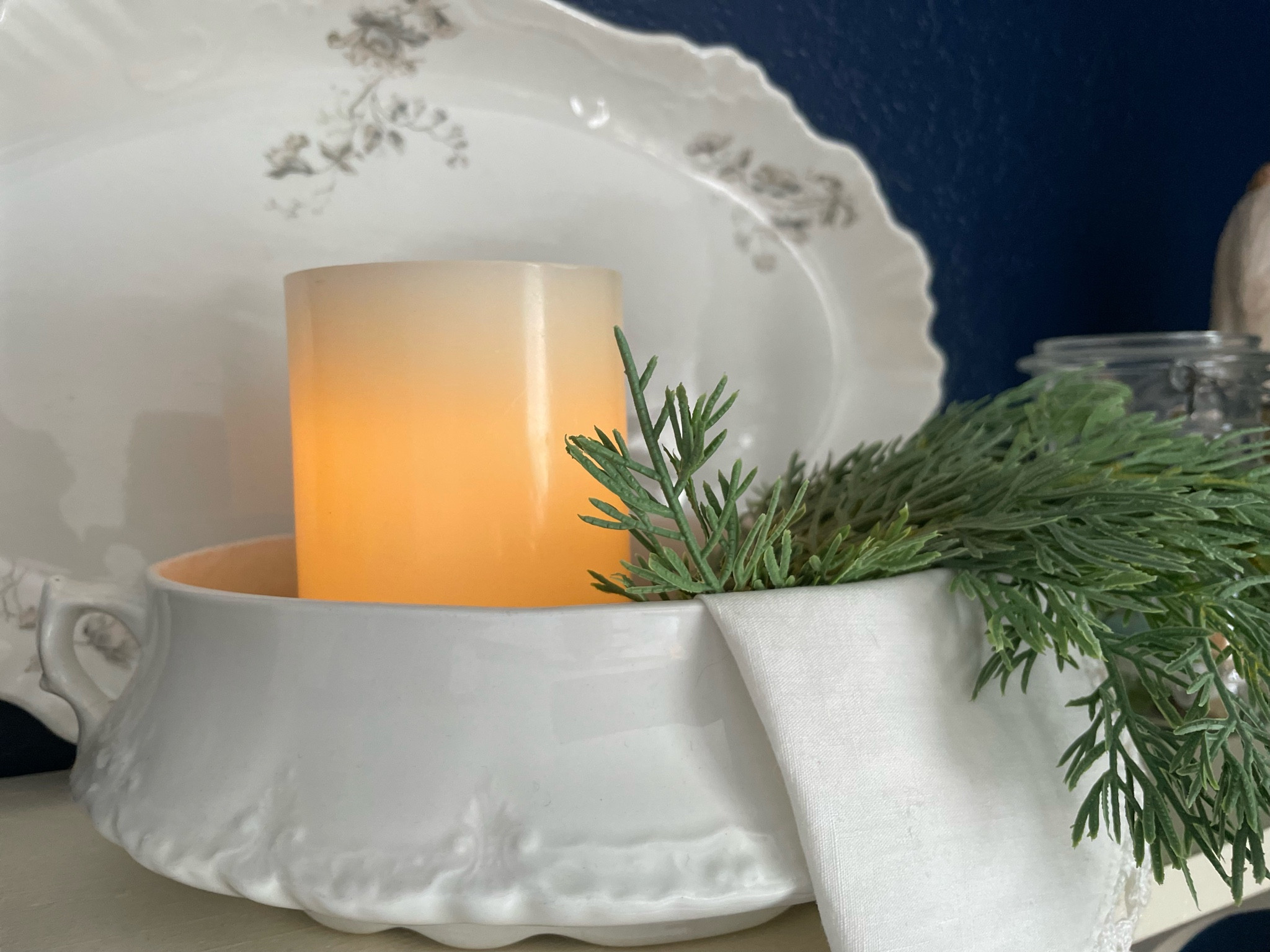 This easy Winter vignette is full of texture and charm. How cozy is that candle nestled amongst the greenery?!

#LTKhome #LTKSeasonal #LTKfindsunder50
