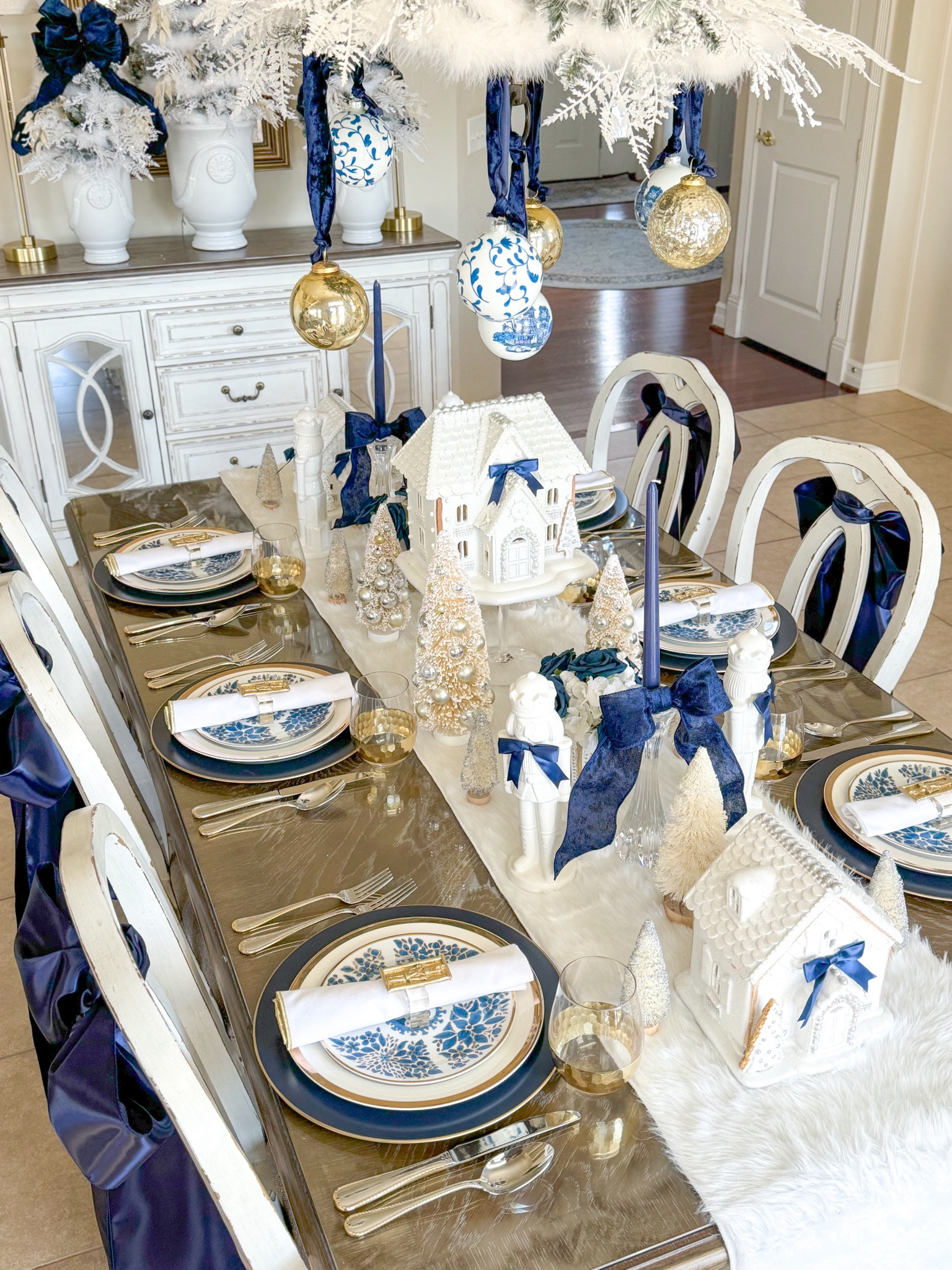 Shop my ming nutcracker table!

Gingerbread house, Ming plates, Ballard designs, navy chargers, crystal candleholders, nutcracker napkin rings, gold napkin rings, blue bows, blue Christmas, blue and white decor, chinoiserie ornaments, bottle brush trees, sisal trees, Christmas decorations, Christmas Tablescape, gold ornaments, velvet ribbon 

#LTKHoliday #LTKSeasonal #LTKHome