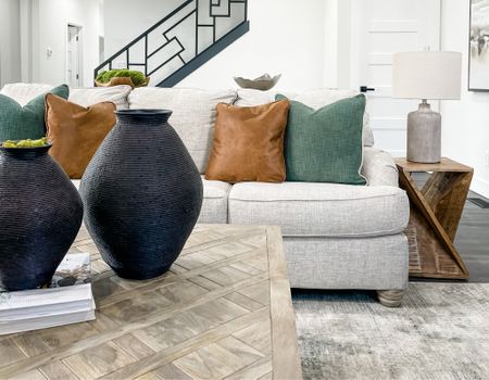 A stunning and cozy family room. We styled the family room with creams, blacks, greens, and wood tones. We love how all the colors and textures complement each other!

#LTKfamily #LTKhome #LTKstyletip