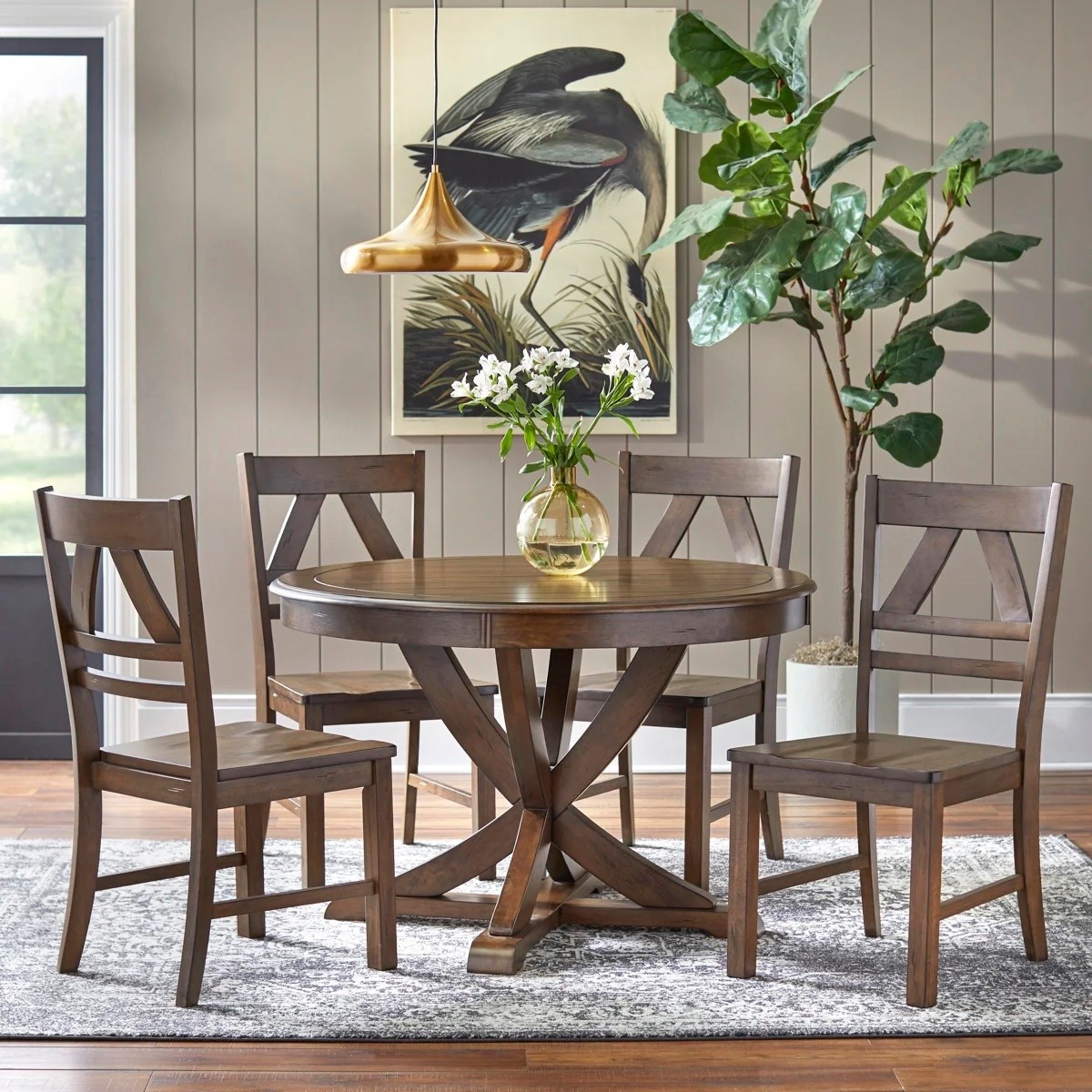 This 5-piece solid wood dining set from Wayfair has such a warm, classic feel without looking too formal. The round pedestal table and four X-back chairs make it feel perfect for everyday meals, and the oak finish adds so much character. I also like that it comes in Antique White and Gray if you want something lighter or cooler. Styled with the neutral area rug, brass pendant light, bird wall art, tall leafy plant, and simple glass vase of flowers, the whole dining nook feels really collected. It’s included in Wayfair’s 72-Hour Closeout right now.