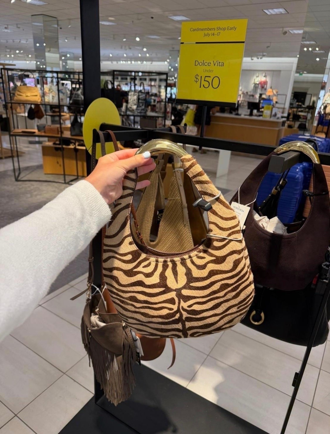If you’re looking to add a fun accessory to your wardrobe, this zebra print shoulder bag is such a good pick. The shape feels modern while the print adds just enough personality to any neutral outfit. It’s one of my favorite statement bags from the Nordstrom Anniversary Sale.

#LTKSaleAlert
