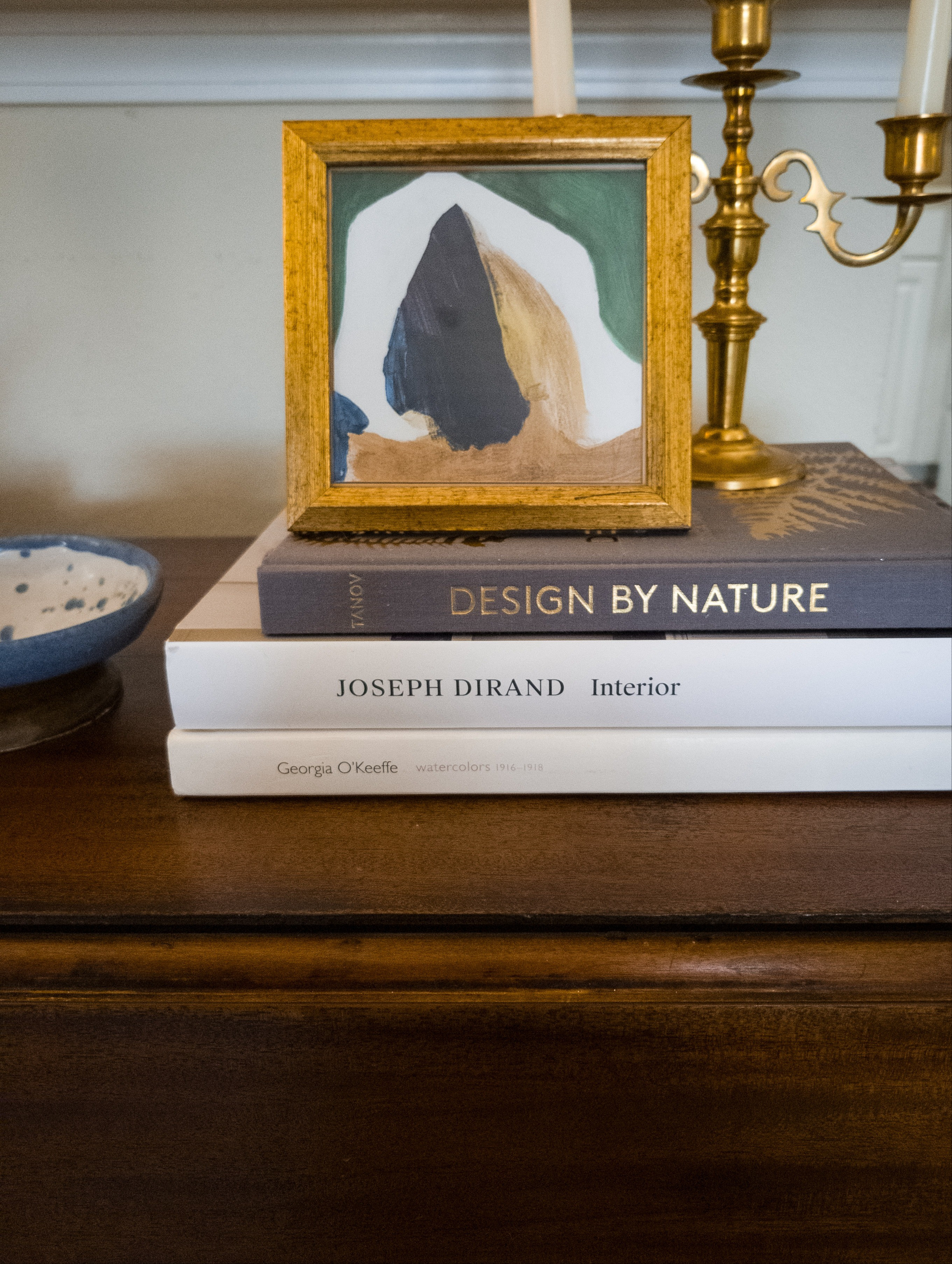 Tabletop style. Home decor. Living room. Console styling. Coffee table books. Design books. Candlesticks. Antique brass candle holders. Decorative bowl. Pottery. Stoneware. Home accents. Vintage modern 

#LTKSeasonal #LTKHome #LTKSaleAlert