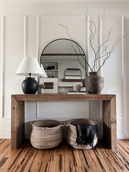 entryway console styling - this console has been my favorite custom made piece gives that modern rustic statement I love. linked very similar style consoles here⬇️

modern rustic. Wood console. Entry. Entryway. Home decor. Neutral decor. Artisan lamp. Vase. Baskets. Arch mirror. Mirror  

#LTKhome #LTKsalealert #LTKstyletip