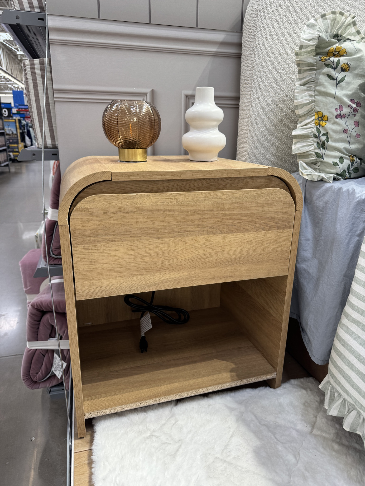 This mid-century modern bedside table from the Drew Barrymore Flower Home line at Walmart is such a gem for anyone who loves that warm, timeless look with a touch of retro charm. The clean lines, tapered legs, and natural wood tone make it the perfect accent piece for a cozy, curated bedroom.

It’s the kind of nightstand that feels designer but is actually so affordable — and the quality is beautiful. The drawer glides smoothly, the finish looks high-end, and it pairs perfectly with both boho-inspired spaces and modern minimalist decor.

Whether you’re styling it with a cute bedside lamp, stacking a few coffee table books, or tucking it next to your Drew Barrymore bedding, it ties the whole space together.

If you’ve been searching for a mid-century nightstand, wood bedside table, or modern boho bedroom furniture, this one checks every box. It’s practical, pretty, and fits perfectly in small spaces, guest rooms, or your main bedroom.

#LTKHome