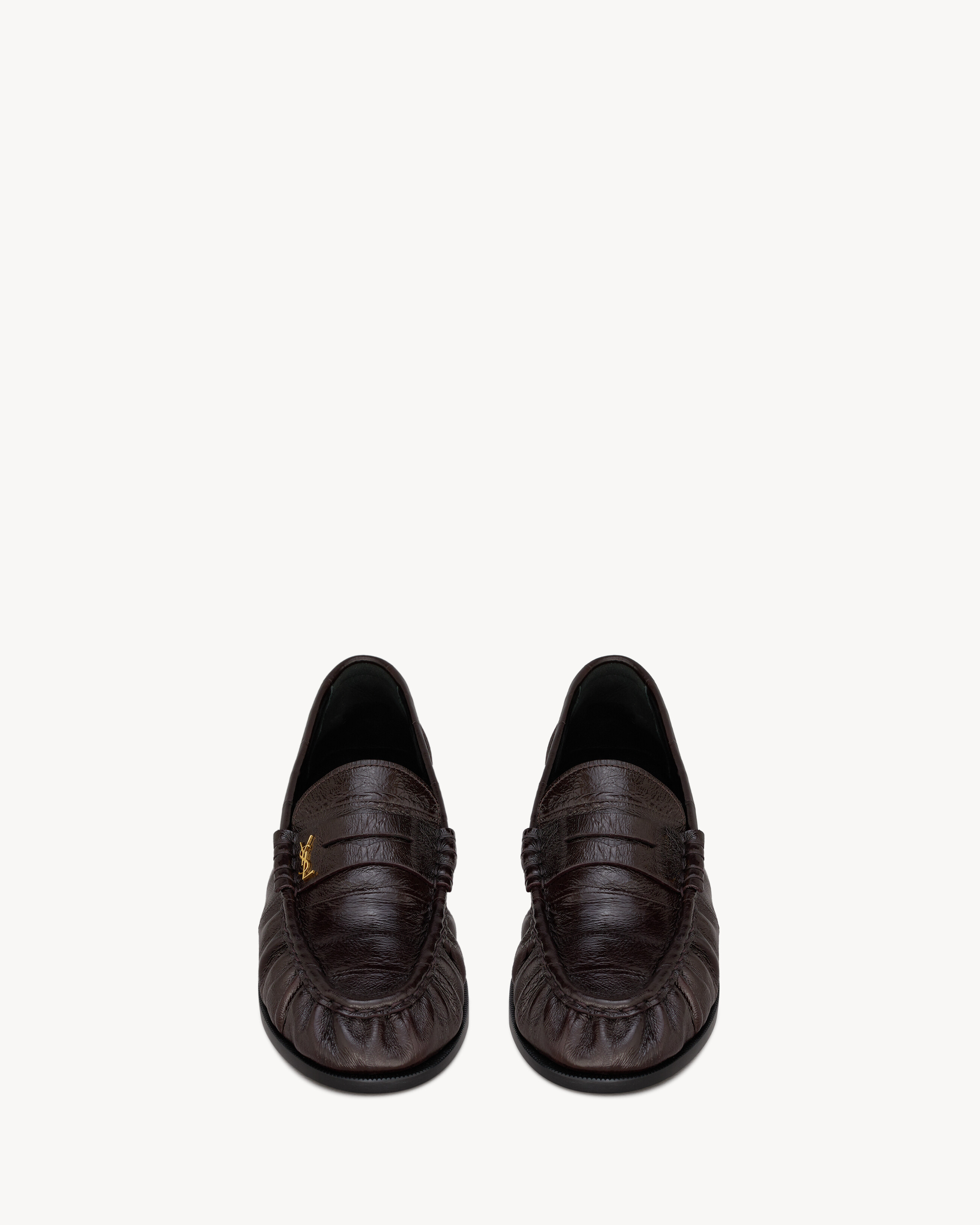 supple penny loafers decorated with the CASSANDRE, featuring a hand-stitched moc toe. | Saint Laurent Inc. (Global)