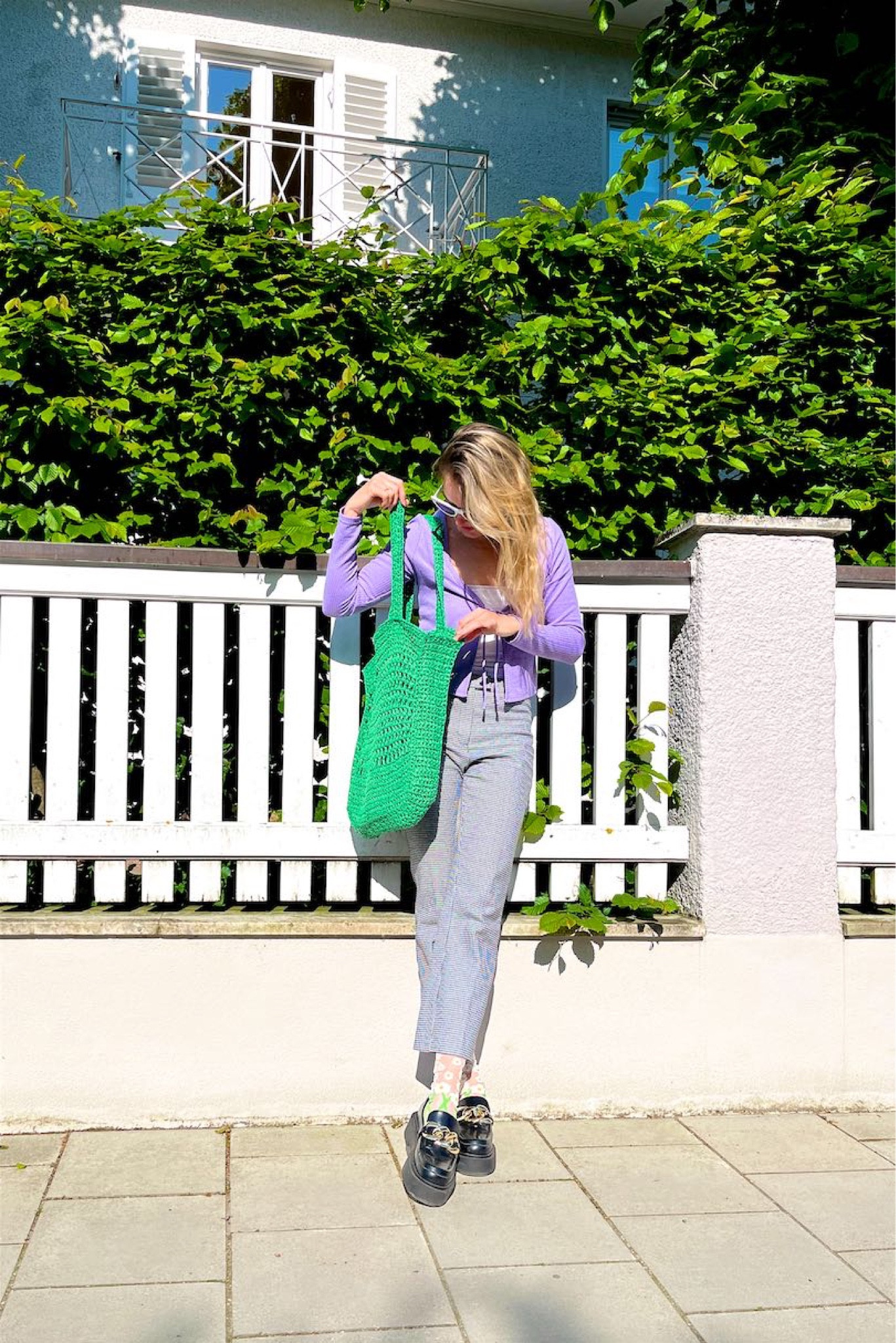 Cute Socks. Fashion Blogger Girl by Style Blog Heartfelt Hunt. Girl with blond hair wearing a purple cardigan, white cat-eye sunglasses, check pants, white top, green straw bag, cute socks and chunky loafers. #colorfuloutfit #colorfulstyle #colorfulfashion #colorfullooks #fashionfun #cutesummeroutfit #summerfashion2023 #summerlookbook #fitcheck #dailylooks #dailylookbook #contentcreator #microinfluencer #discoverunder20k 