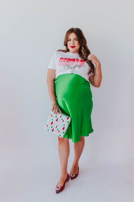 curvy merry merry merry Christmas graphic tee and kelly green satin skirt! part of my Merry Pinkmas collection with Pink Desert! i’m in the xxl in tee and 2X in skirt (has an elastic waistband), typically would take the large not pregnant. runs TTS!  🎄🩷

#LTKfindsunder100 #LTKHoliday #LTKmidsize