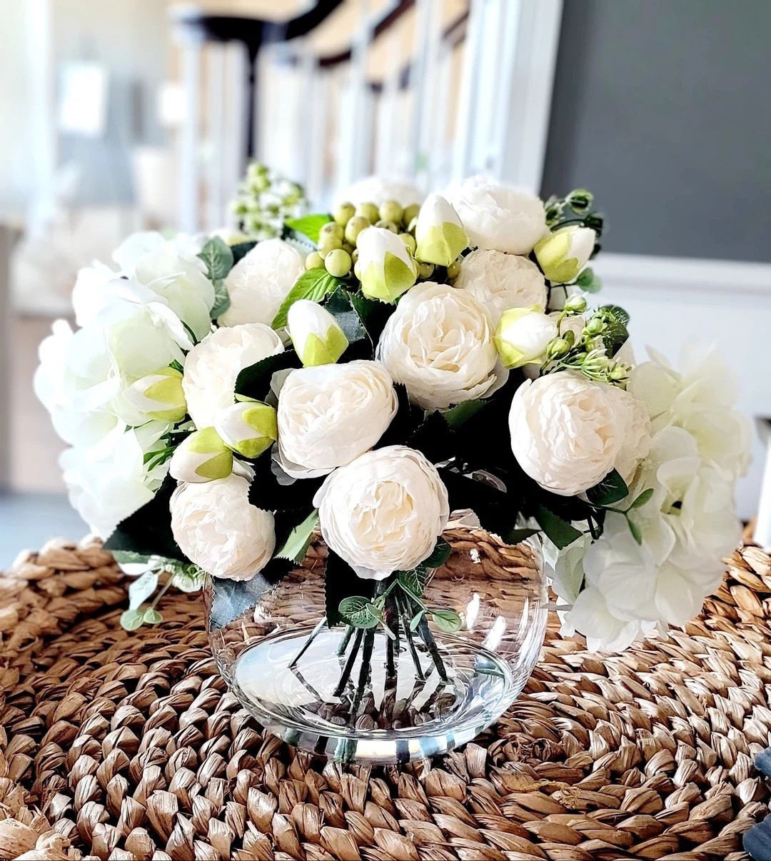 Elevate your space with this stunning faux peony and hydrangea arrangement designed in a large glass vase with realistic water detailing for a fresh-cut look that lasts forever. The soft peonies paired with full white hydrangeas create an elegant, timeless centerpiece perfect for modern farmhouse, French country, or classic home décor. Whether styled on a dining table, entryway, or coffee table, this beautiful arrangement adds effortless charm and makes a thoughtful gift for Mother’s Day, housewarmings, or weddings.

#LTKHome #PeonyDecor #HydrangeaDecor #FarmhouseDecor #SpringDecor #HomeDecorIdeas #FloralCenterpiece #ElegantHome #FauxFlorals #ForeverFlowers #FrenchCountryDecor #ModernFarmhouse #GiftIdeas #HomeInspiration #LTKFinds

#LTKHome #LTKSeasonal #LTKWedding