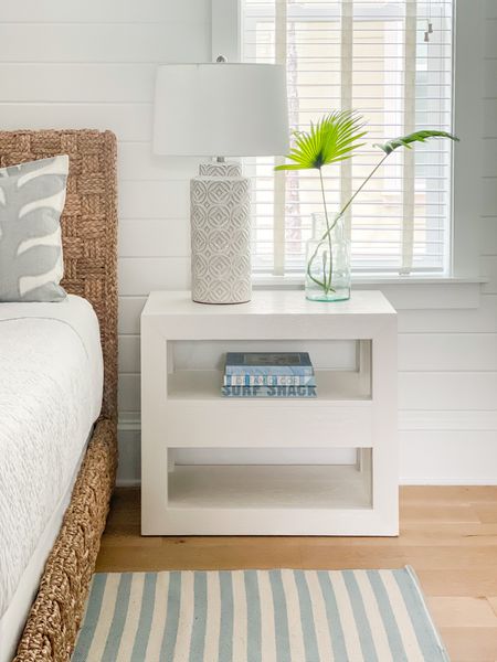 Loving these updates we made to the primary suite at our 30A vacation rental, Hola Beaches! Includes a woven bed, white nightstand, a light blue striped rug, ceramic lamps, coastal coffee table books, and faux fan palms!
.
#ltkhome #ltkseasonal #ltksalealert #ltkunder50 #ltkunder100 #ltkstyletip #ltktravel #ltkfind bedroom decor, coastal bedroom ideas, simple bedroom decor

#LTKhome #LTKsalealert #LTKSeasonal