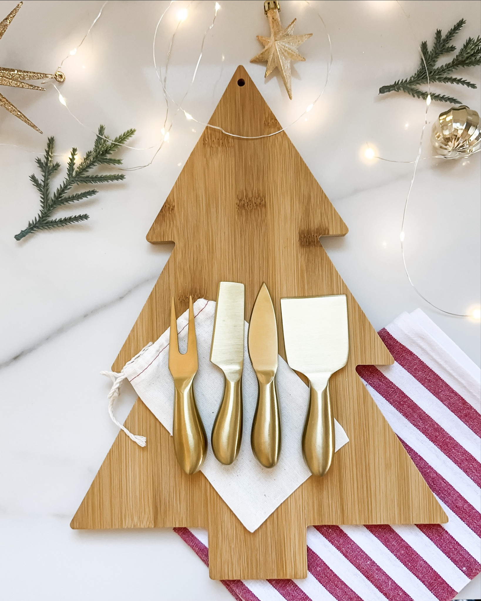 Christmas Charcuterie Gift | charcuterie board  Christmas tree board  cheese knives  holiday bow  neutral bag  gold ornaments  holiday hostess  hostess gift  kitchen gift  seasonal gift

#LTKHoliday #LTKGiftGuide #LTKFindsUnder50