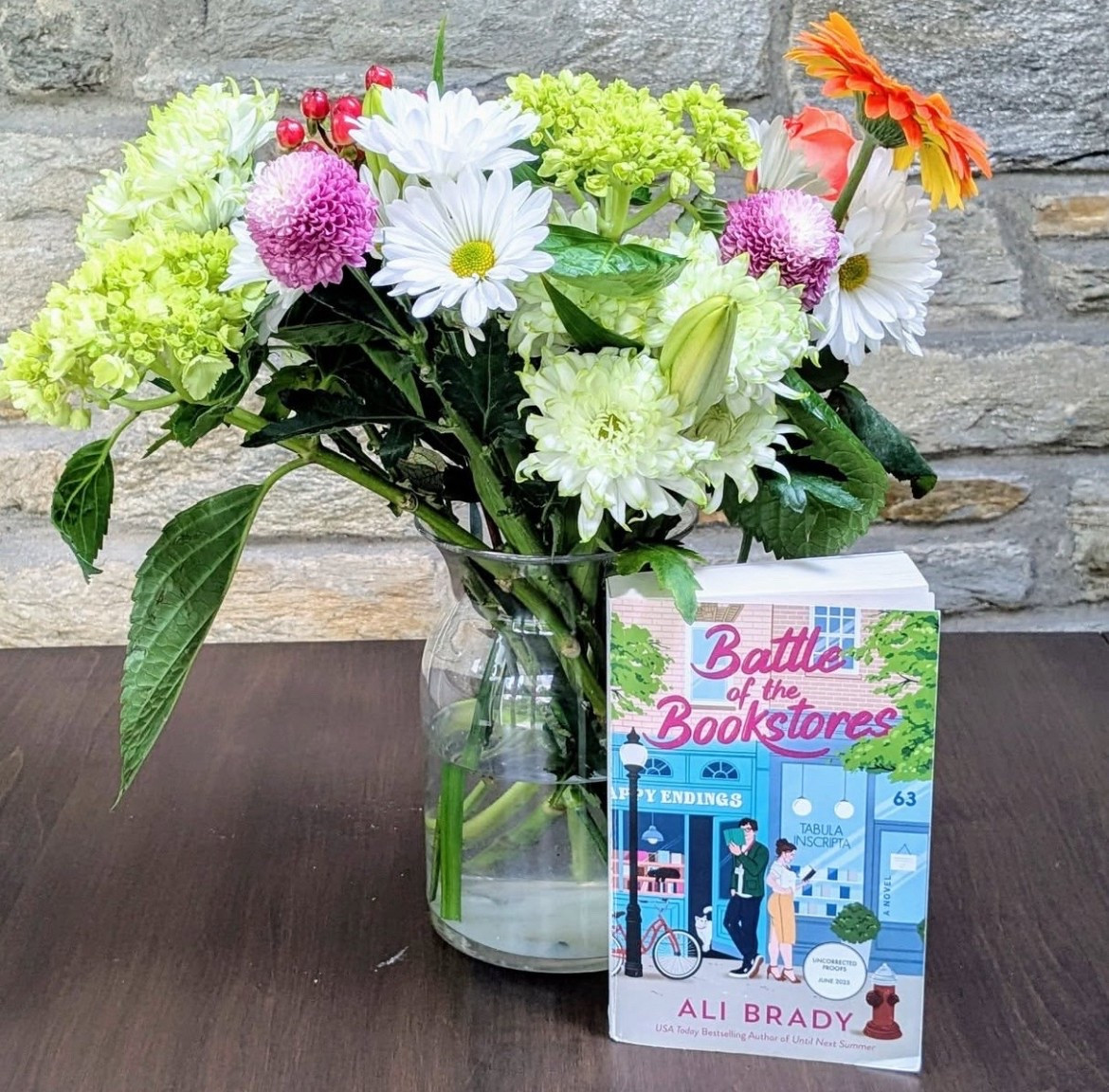 Battle of the Bookstores by Ali Brady ⭐⭐⭐⭐💫

Pub Date: June 3, 2025
Pages: 432
Audiobook Length:  12 hours

We had the pleasure of being part of the #teamenemiestolovers on the traveling arc book tour of #battleofthebookstores Thank you @alibrady for this opportunity! 

Bethany's Review: This book solidified the reason why I love Ali Brady books! The enemies to friends to lovers, the Jewish rep, books about indie bookstores, opposites attract, the banter – all of it! I loved both characters: Josie and Brian – I mean Ryan. The relationship between them and between the side characters was wonderful to read about. What makes it even better is they felt relatable. I fell in love with all of them. I love the literary references throughout the entire story. The ending of the book was perfection! I can’t wait to see what they come up with next! 

Sara's Review: I absolutely love Ali Brady books - and this one did not disappoint. It had all my favorites - enemies to lovers, bookstores, jewish representation, big city  with a small town feel. I just loved it all. The characters were adorable - their banter, their chemistry, the growth and change throughout the book. They were well developed and wonderful. I loved the banter and the constant connection and importance of books in the story. I felt like I actually knew the characters, that they were friends or family members and I was so upset when the book ended! Despite it being a long book, I FLEW through it - read it in less than 48 hours! This book felt like a warm hug (even when I found myself crying!) Do yourself a favor and preorder this for the summer! 

#LTKOver40 #LTKFindsUnder50 #LTKSeasonal