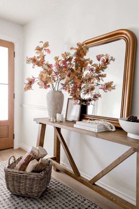 Fall entryway decor 🍁 The console table, beautiful faux autumn oak branches, and the mirror from Ballard Designs are all on sale this weekend! 

#cozy #falldecor #frontdoor #hallway #leaves 

#LTKhome #LTKsalealert #LTKSeasonal