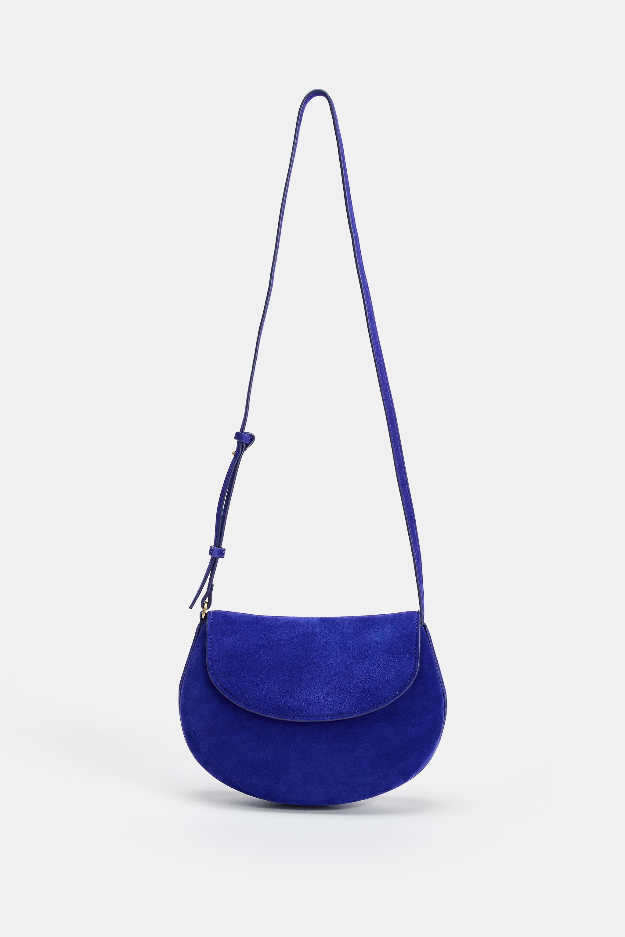 Leather crossbody bag. Adjustable strap. Interior zip pocket. Flap with metallic clip closure.Hei... | Zara US