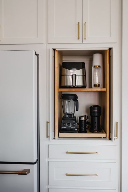 Appliance garage in our kitchen. I had this custom made when we were building our home then had a cabinet craftsman add the shelves to hold our air fryer, soda steam, vita mix and Nespresso! Also linking our gold hardware 
