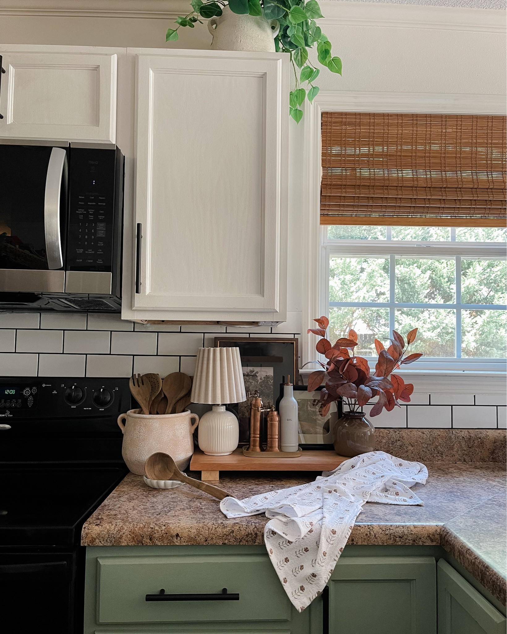 Kitchen countertop styling ideas. Fall countertop styling. Hearth and hand table lamp. Floral kitchen towel. Utensil holder. Bamboo Roman shades. Small wall art. 

#LTKHome #LTKSeasonal #LTKFallSale