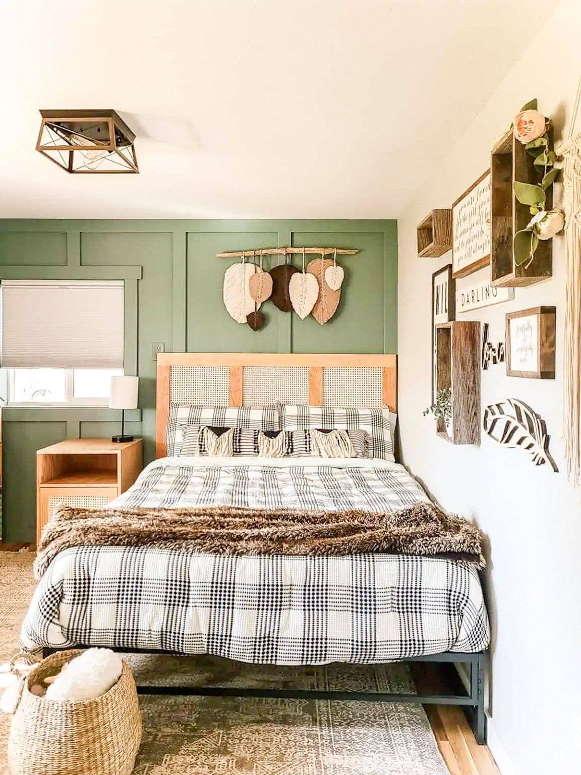 This bedroom mixes so many textures and styles I love: a green board and batten wall for warmth, cane and rattan pieces for that boho touch, and black and white plaid bedding to keep it from feeling too soft. Feather wall art and a few boho accents round it out for a room that feels layered but still calm. #bedroom #boho 

 #LTKHome