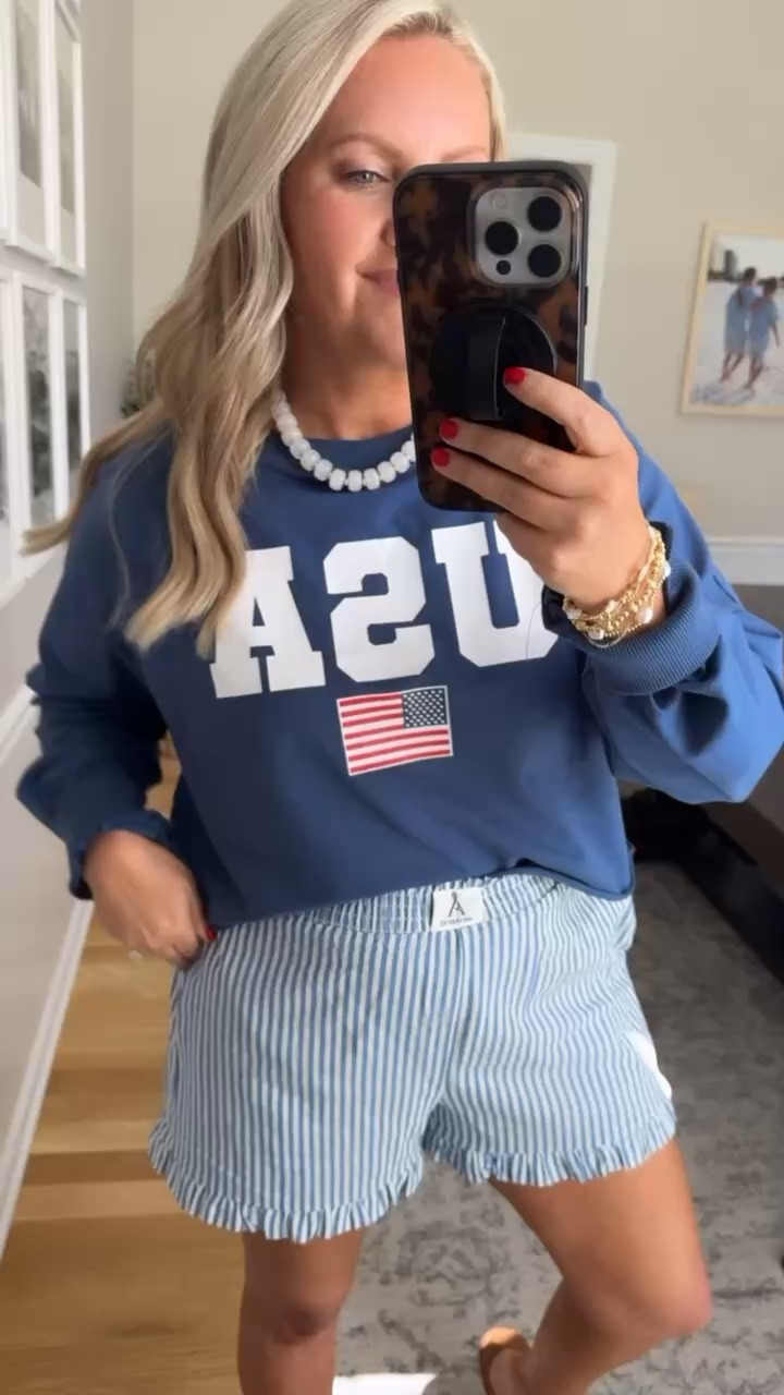 This USA sweatshirt and striped boxer shorts combo is the definition of cute and comfy for Memorial Day weekend. The oversized fit feels relaxed, the blue tones are so good together, and this is the kind of outfit you’ll throw on for coffee runs, lake days, backyard BBQs, and everything in between.

Memorial Day outfit, patriotic outfit idea, USA sweatshirt, boxer shorts outfit, comfy summer outfit, casual mom style, Fourth of July outfit, red white and blue outfit, weekend outfit inspo, cozy patriotic look, striped shorts outfit, easy everyday style, lovelylifestyling

#LTKootd #LTKSeasonal #LTKTravel