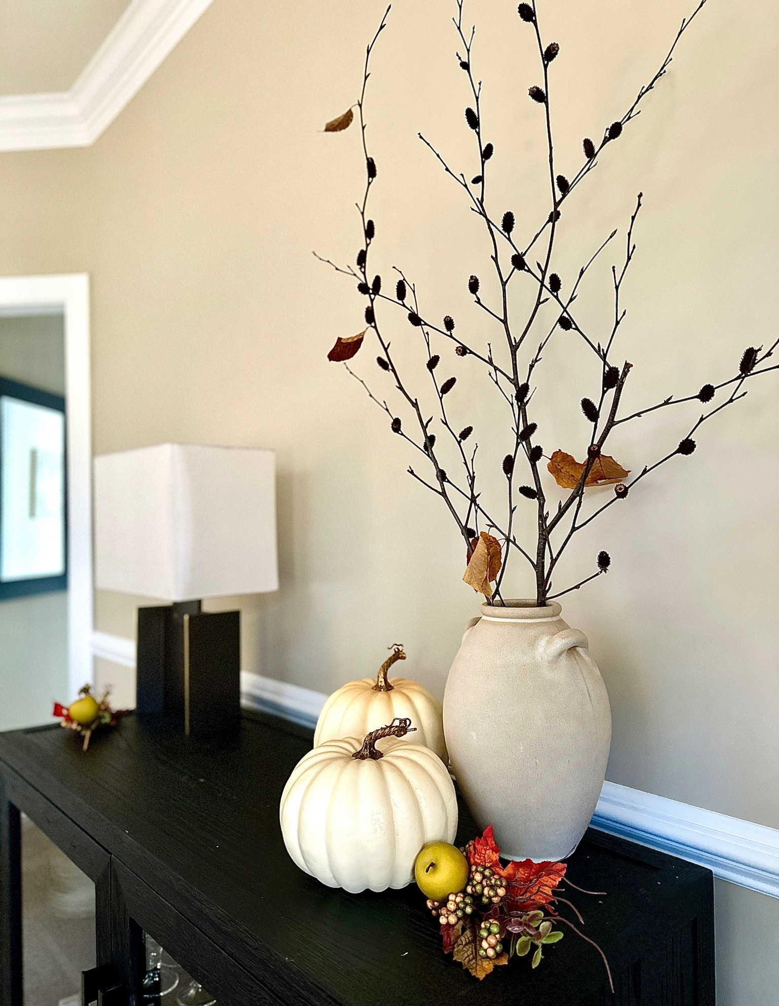 Simple organic and rustic dining room console styling for thanksgiving hosting as you get ready to transition to holiday. 

I styles a natural branch (found in back yard) in a neutral organic modern vase with neutral faux pumpkins. 

Dining room decor // fall decor // rustic decor // organic modern // dining room console contemporary // modern cabinet with glass doors 

#LTKSeasonal #LTKhome #LTKfindsunder50