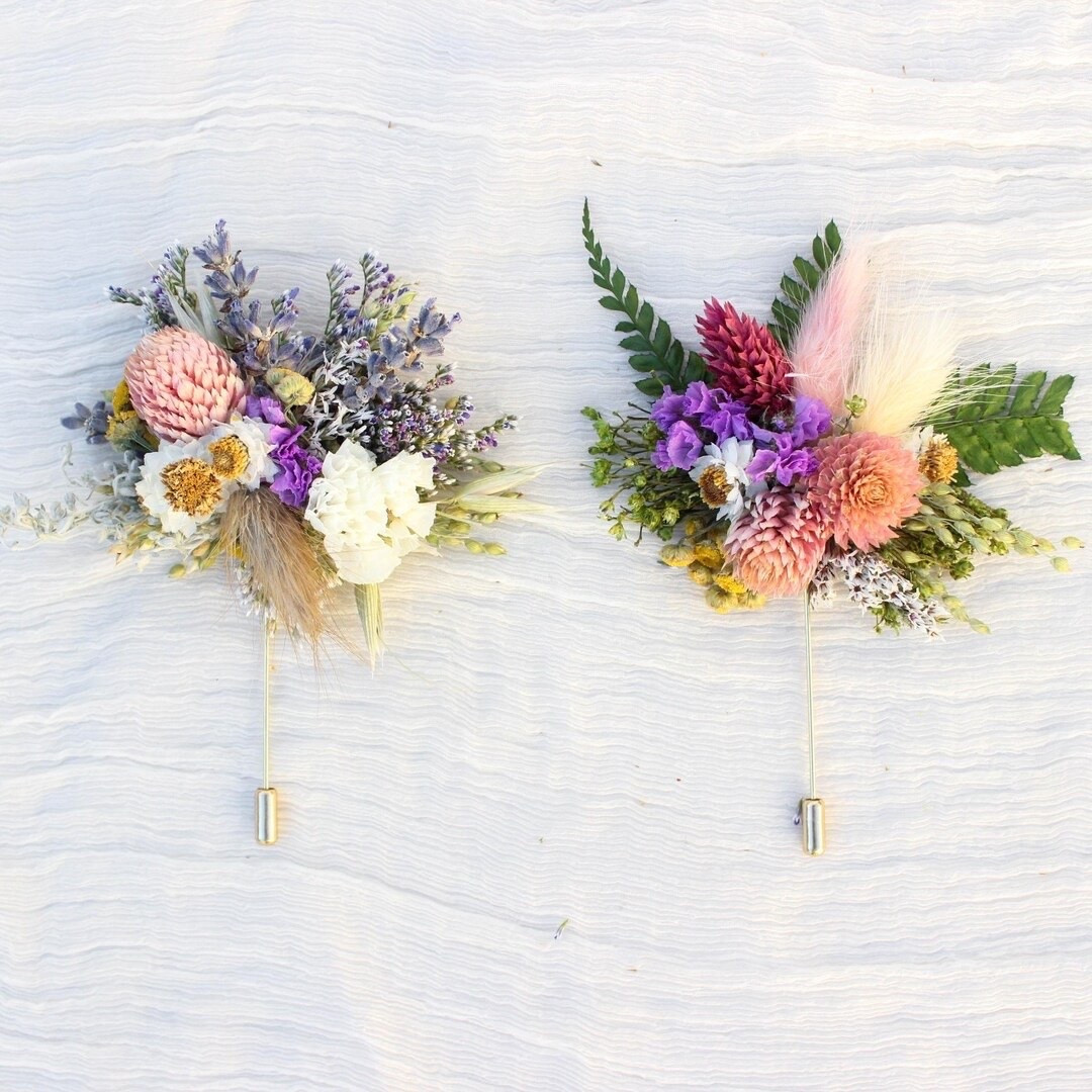 Add a natural, bohemian touch to your wedding day with this handcrafted dried flower boutonniere. Designed with preserved roses and delicate dried blooms, this timeless accessory is perfect for grooms, groomsmen, and special celebrations. Lightweight and full of texture, each piece is uniquely handmade and offers lasting beauty long after the event is over. #DriedFlowerBoutonniere #GroomsmenStyle #BohoWedding #WeddingAccessories #PreservedFlowers #RusticWedding #GroomStyle #EverlastingFlowers #LTKWedding #WeddingInspiration

#LTKWedding #LTKMens #LTKSeasonal
