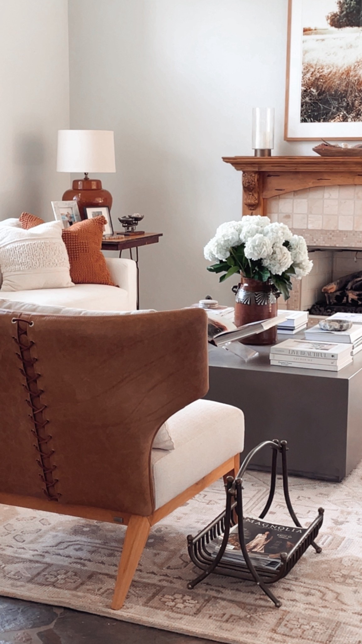 Living room with layered neutral home decor. Large square coffee table styling. Nicolette area rug from Pottery Barn. 

#LTKHome