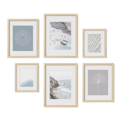 six framed coastal prints arranged in a gallery grid