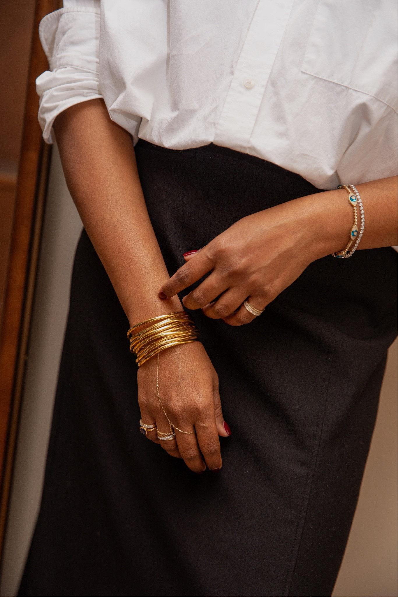 Gold bangles 
Solid gold hand chain 
Diamond evil eye tennis bracelet 

#LTKparties #LTKstyletip #LTKeurope