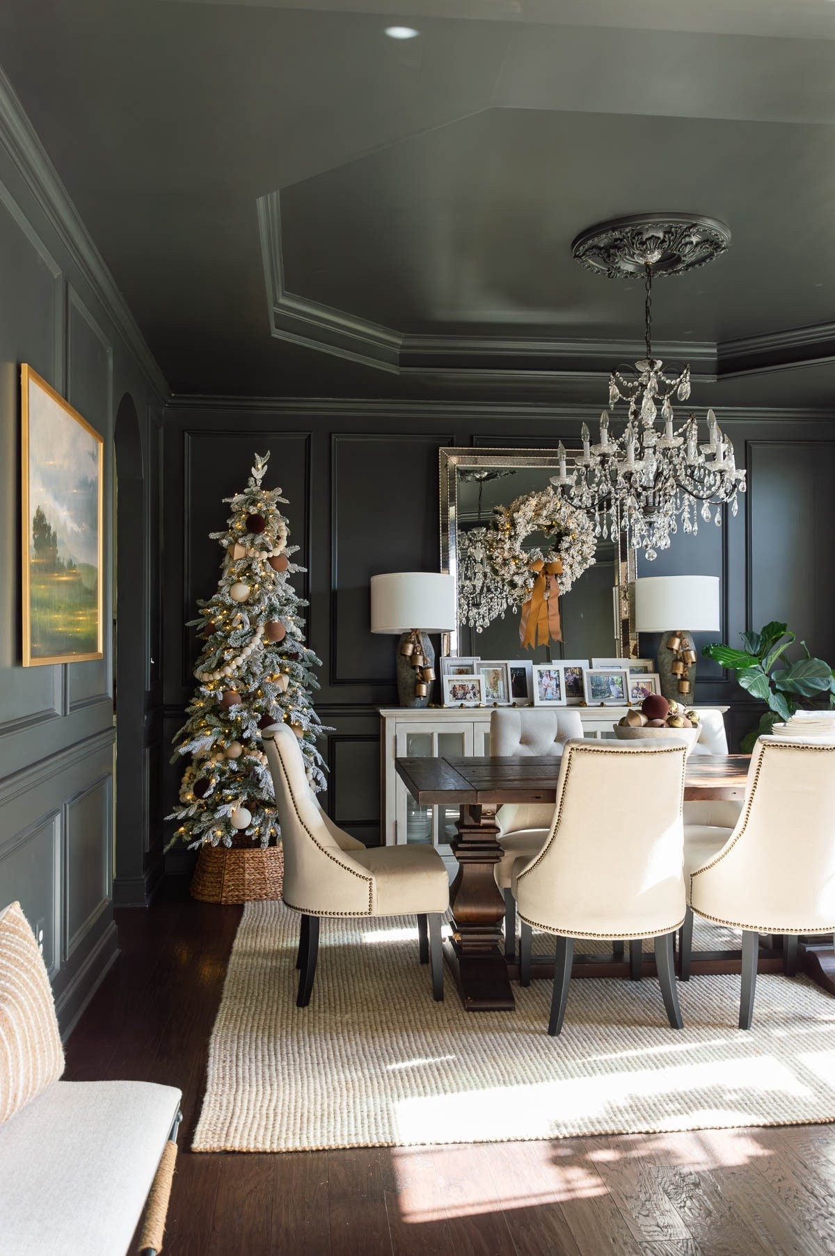 I think the Iron Ore walls and ceiling in my dining room provide the perfect backdrop for holiday decor. I’ve added a slim flocked Christmas tree, decorated simply with neutral colored ornaments and large cream ball garland. A rattan tree collar completes the look. This year I added my gallery of our Christmas photo cards to the sideboard and added an arrangement of bells and balls in a wooden bowl to the dining table. home decor dining room decor Christmas decor crystal chandelier wool jute rug landscape art dining chairs

#LTKHoliday #LTKStyleTip #LTKHome