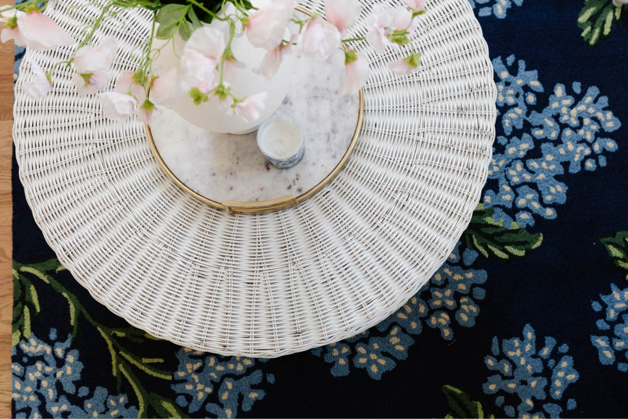 Styling tip: Trays are a design lifesaver! 🖤 They neatly corral everyday items like candles, vases, and books, instantly giving surfaces like your coffee table a pulled-together look. I love using trays not just for coffee tables but also on consoles and nightstands—perfect for creating intentional zones in any room. Whether you're layering decor, adding height with stacked items, or organizing essentials, trays help bring both beauty and function to your space!

Speaking of elevated design… how gorgeous is this combo? The classic wicker coffee table (still available!) paired with that stunning floral rug creates a perfect blend of texture and color. 🌸 Both were hand-selected as part of #ProjectGrandmillennial, a transformation with Traditional, European, and classic style elements. From rugs to art to timeless furniture pieces, this project is full of inspiration!

#LTKHome