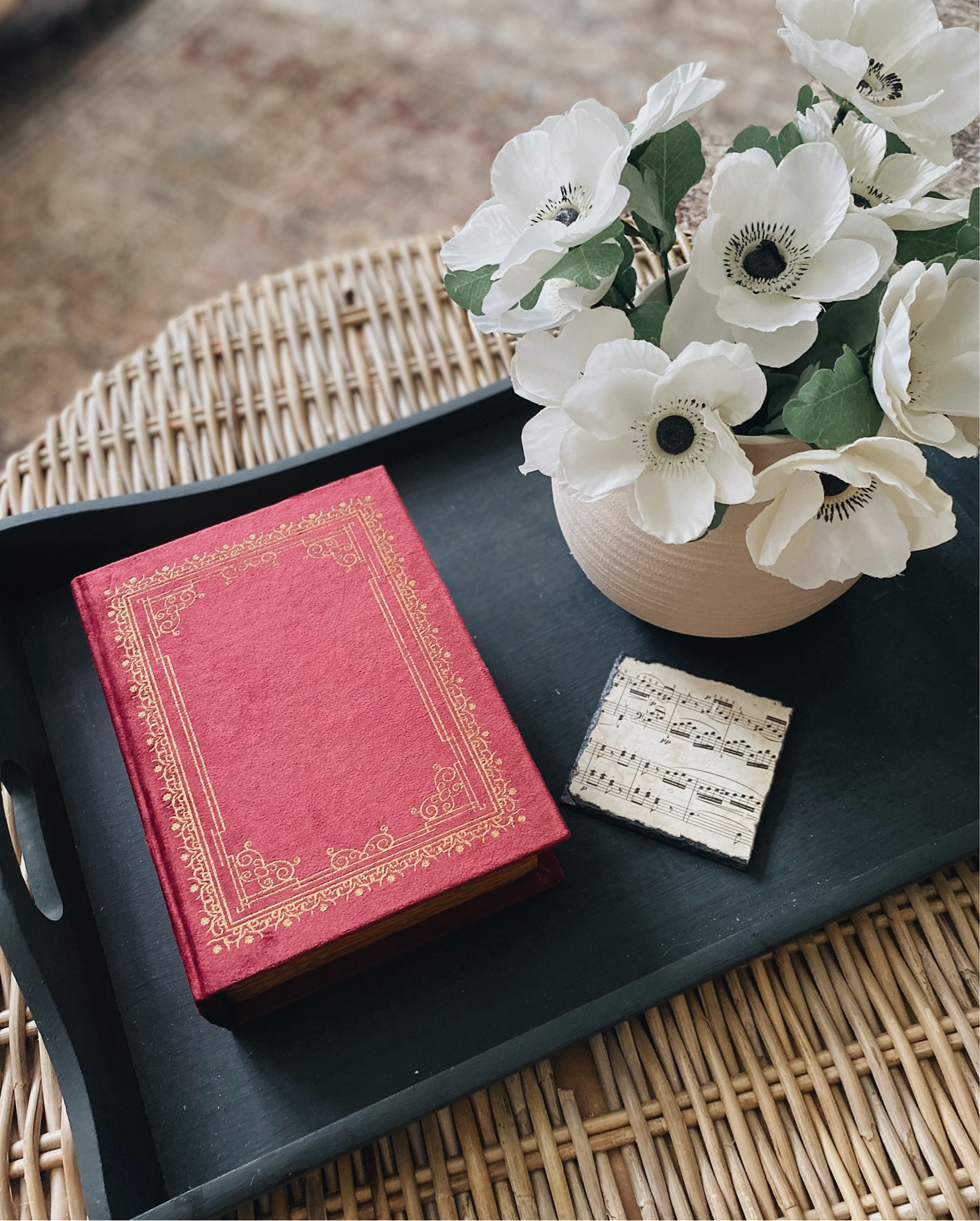 Coffee table styling
I thrifted and painted the tray in the color Blackboard by Magnolia Home 
Vintage book storage box | coaster | music theme | anemones | neutral ceramic vase | storage organization 

#LTKFindsUnder50 #LTKStyleTip #LTKHome