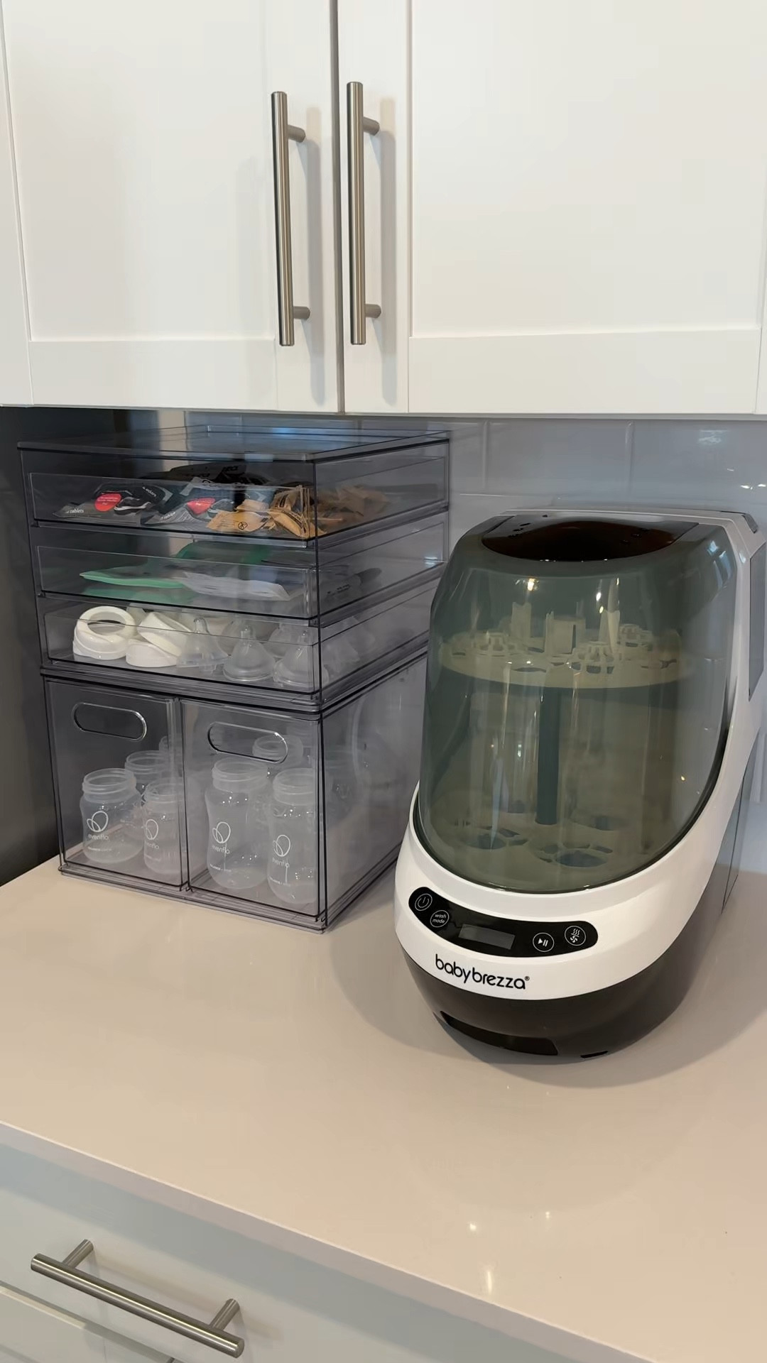 don’t love things on my counter but the organization helps✨🫶🏻 #bottlestation #bottleorganizer #acrylicorganizer #babybrezzabottlewasher #nesting #firsttimemom #2025mom #registrymusthaves 

#LTKBump #LTKFamily #LTKBaby