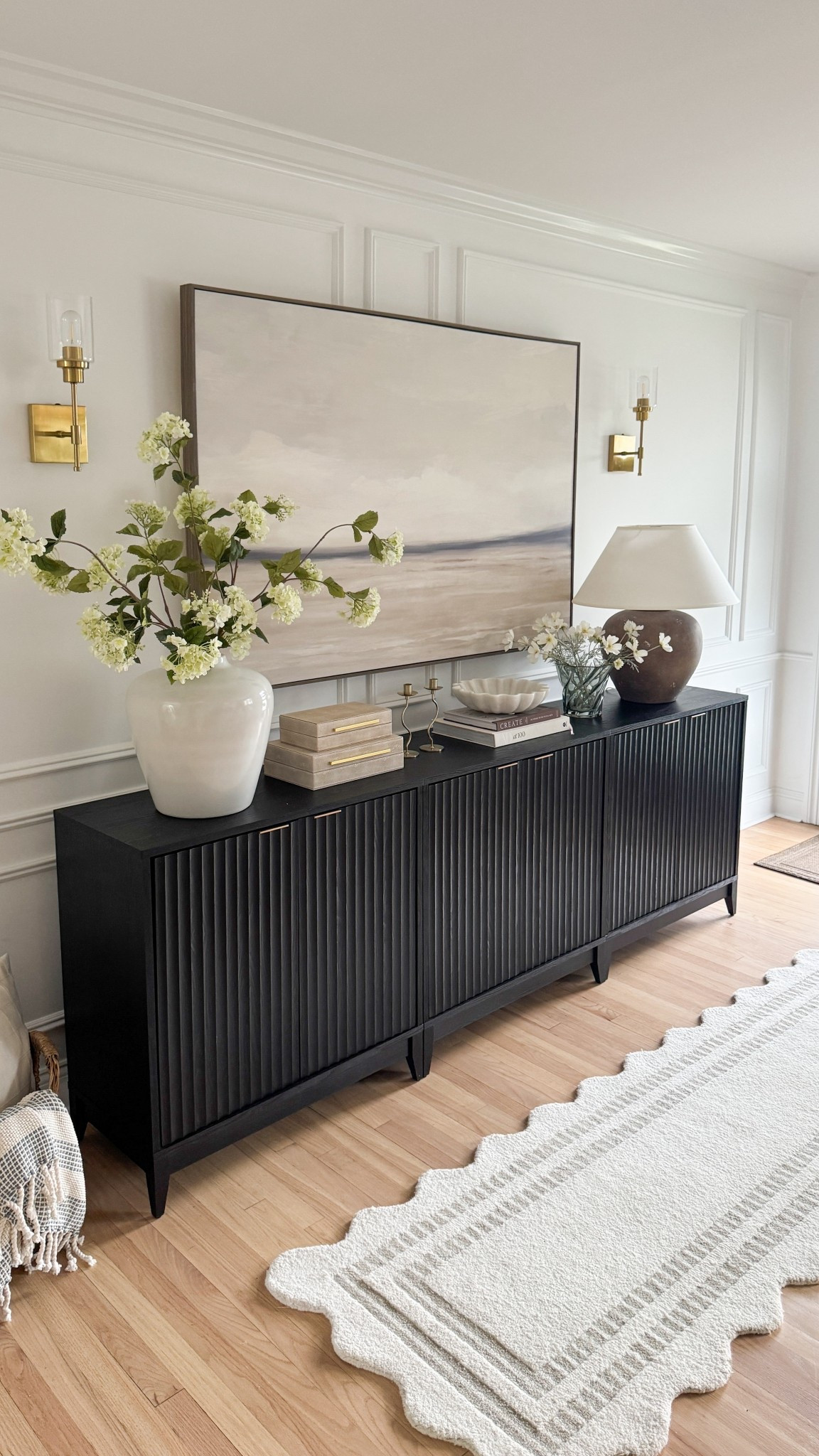 This little corner came together better than I imagined 🤍
I’ve been getting so many questions about this black fluted sideboard — it adds the perfect contrast and texture to our space. I styled it with a few favorite Amazon and Wayfair finds, and of course… faux florals always do the trick 👏🏼

#LTKHome #ModernOrganicStyle #NeutralHomeVibes #EntrywayDecor #ConsoleStyling #HomeInspoDaily #BlackCabinet #AmazonHomeFinds 


#LTKStyleTip #LTKHome #LTKFindsUnder100
