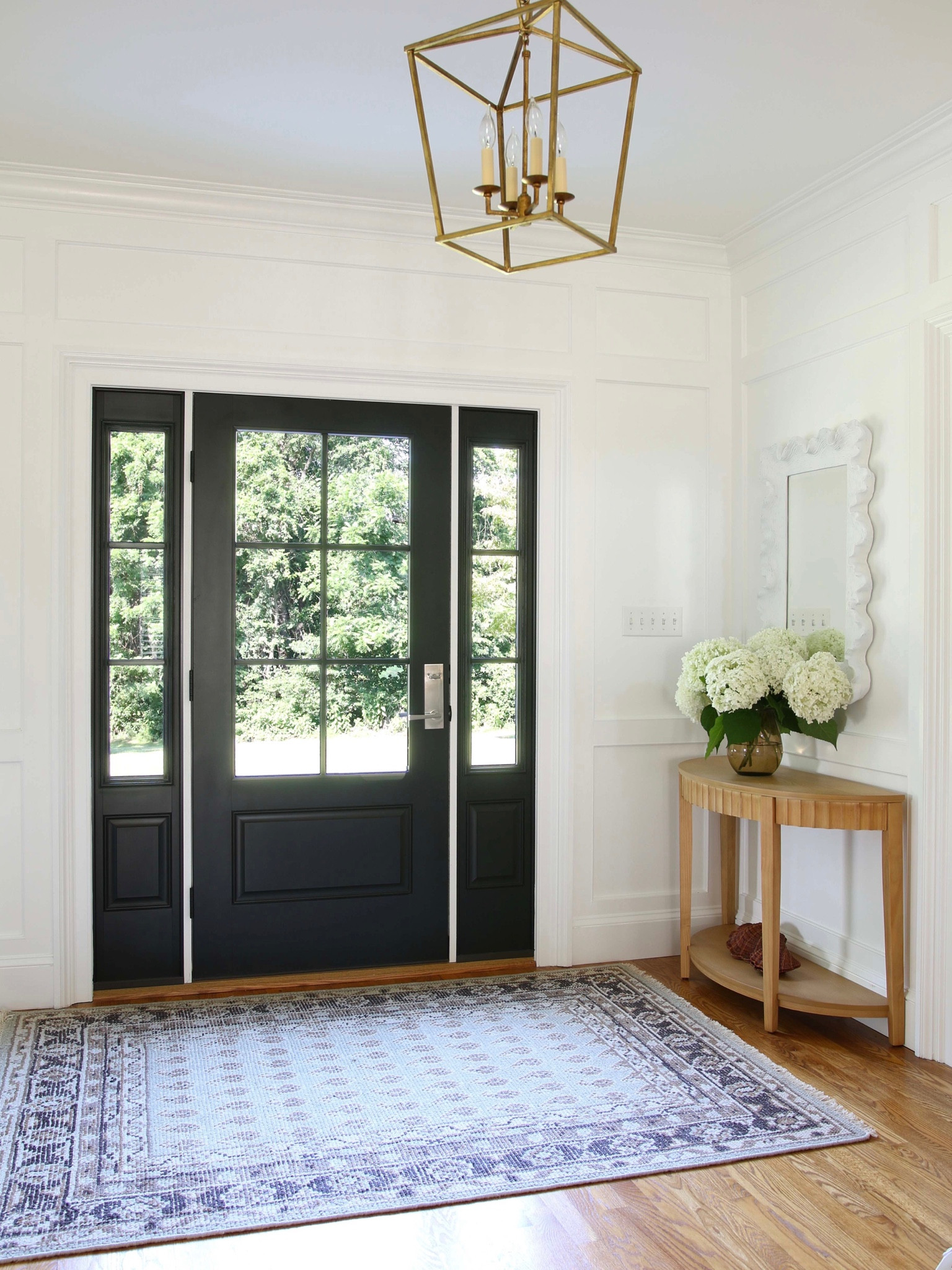 A current view of my entryway. I updated the 4 bulb pendant to glided iron. The scalloped wood console table and hand knotted rug are from Target Studio McGee and the scalloped mirror is from Ballard Designs

#LTKstyletip #LTKFind #LTKhome