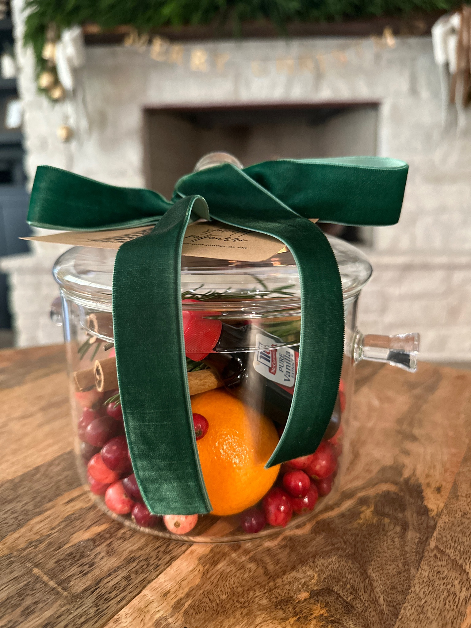 make your own stovetop potpourri simmer pot - great for teacher gift, hostess gift, neighbor gift 🎁  clementines, apples, fresh cranberries, rosemary, vanilla, cinnamon sticks, glass pot, velvet ribbon 

#LTKHoliday #LTKfindsunder50 #LTKSeasonal