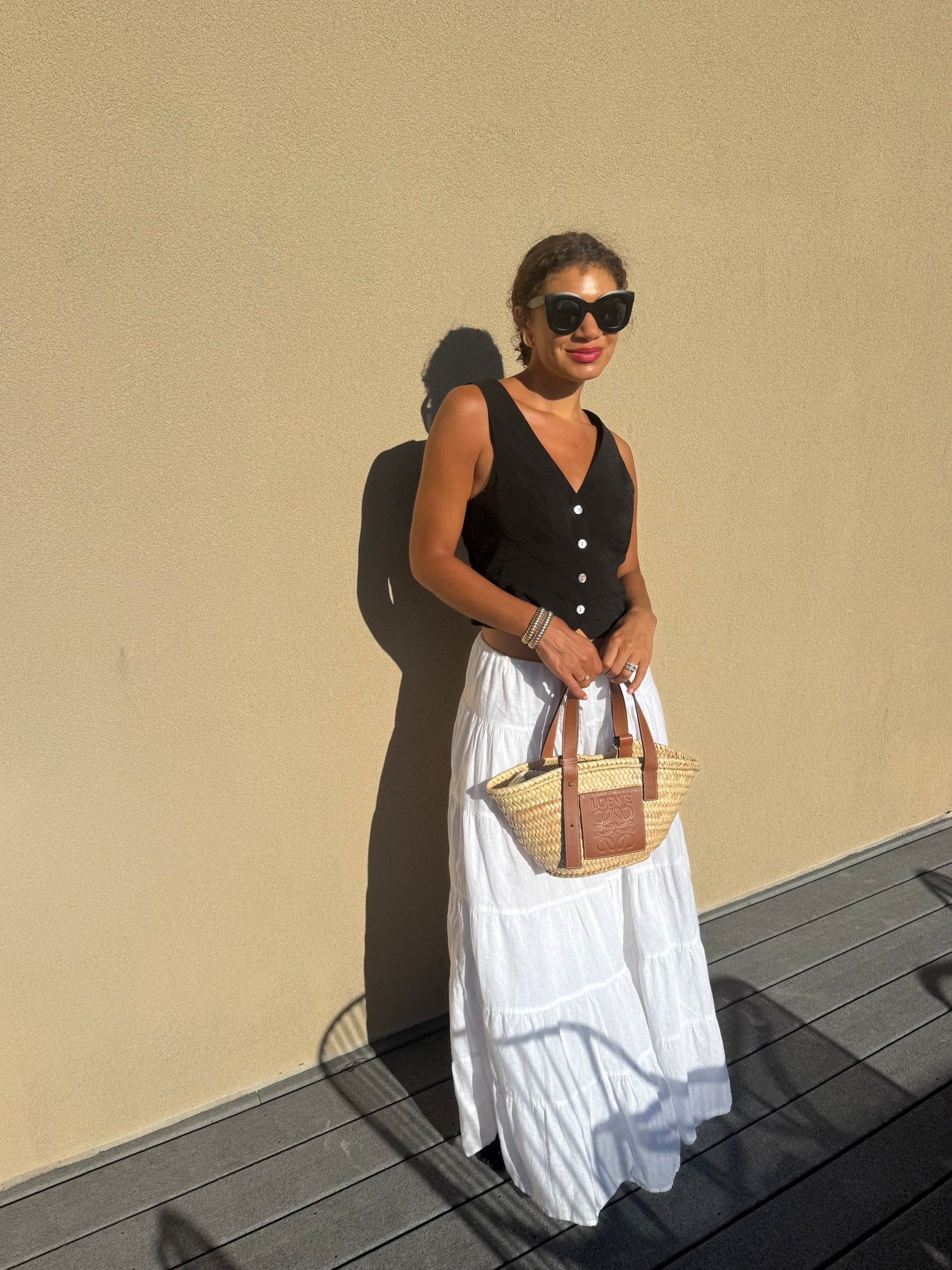 Warm weather outfit: white skirt, black vest, straw bag 

#LTKootd