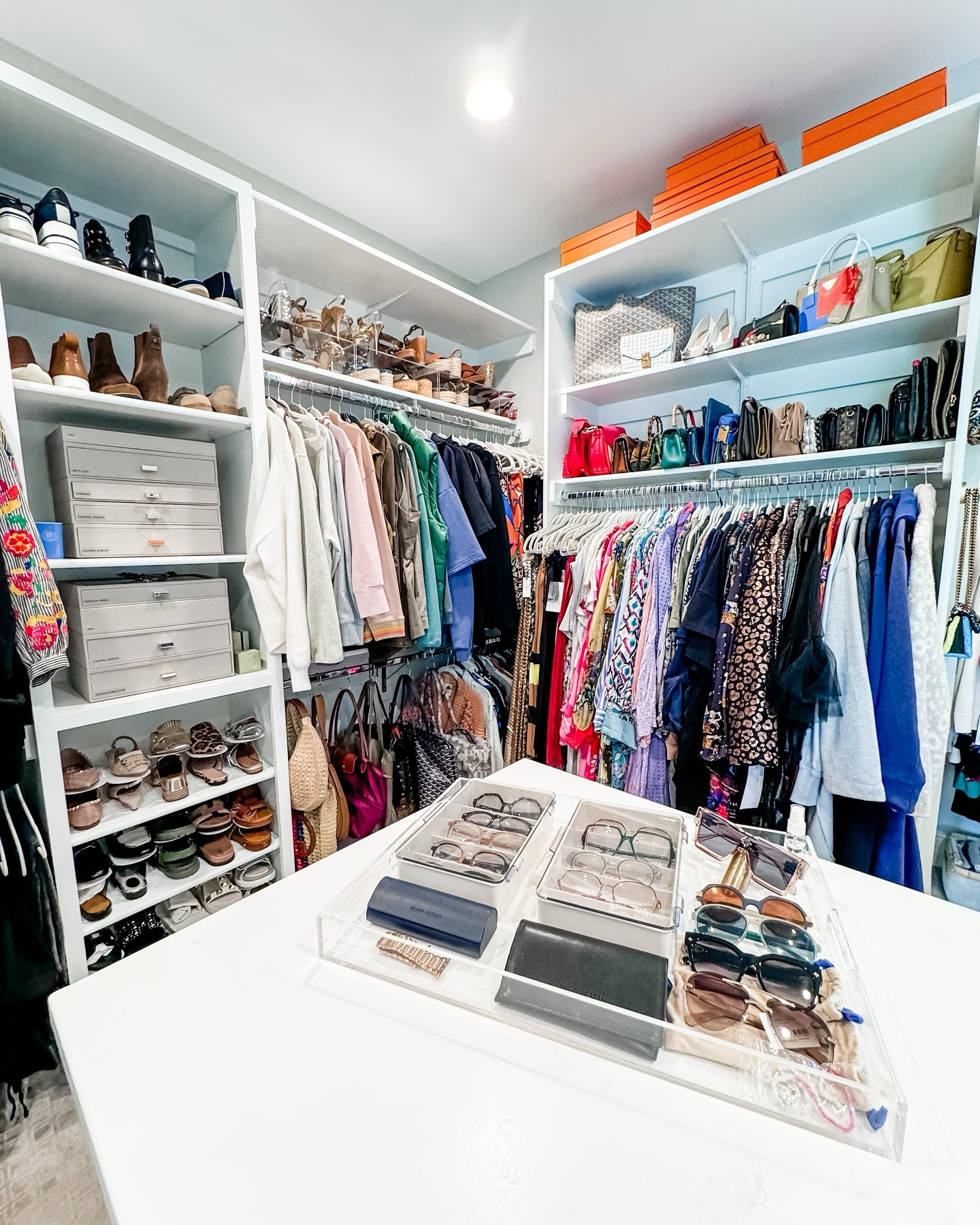 Every project starts with a consultation where we chat all about your goals for your space…and when your goal is editing out the items that no longer bring you joy and creating a system where things are visible, we roll up our sleeves and get to work!

Trim closets can be tricky because shelves can’t be adjusted, so we added these discreet luxe acrylic monitor stands to double the amount of shoes on the upper shelves. 

Yes…monitor stands (like for a computer).

Seeking out the perfect mix of products to help your collections shine is the icing on the cake of each organizing project! Now, what to wear?!