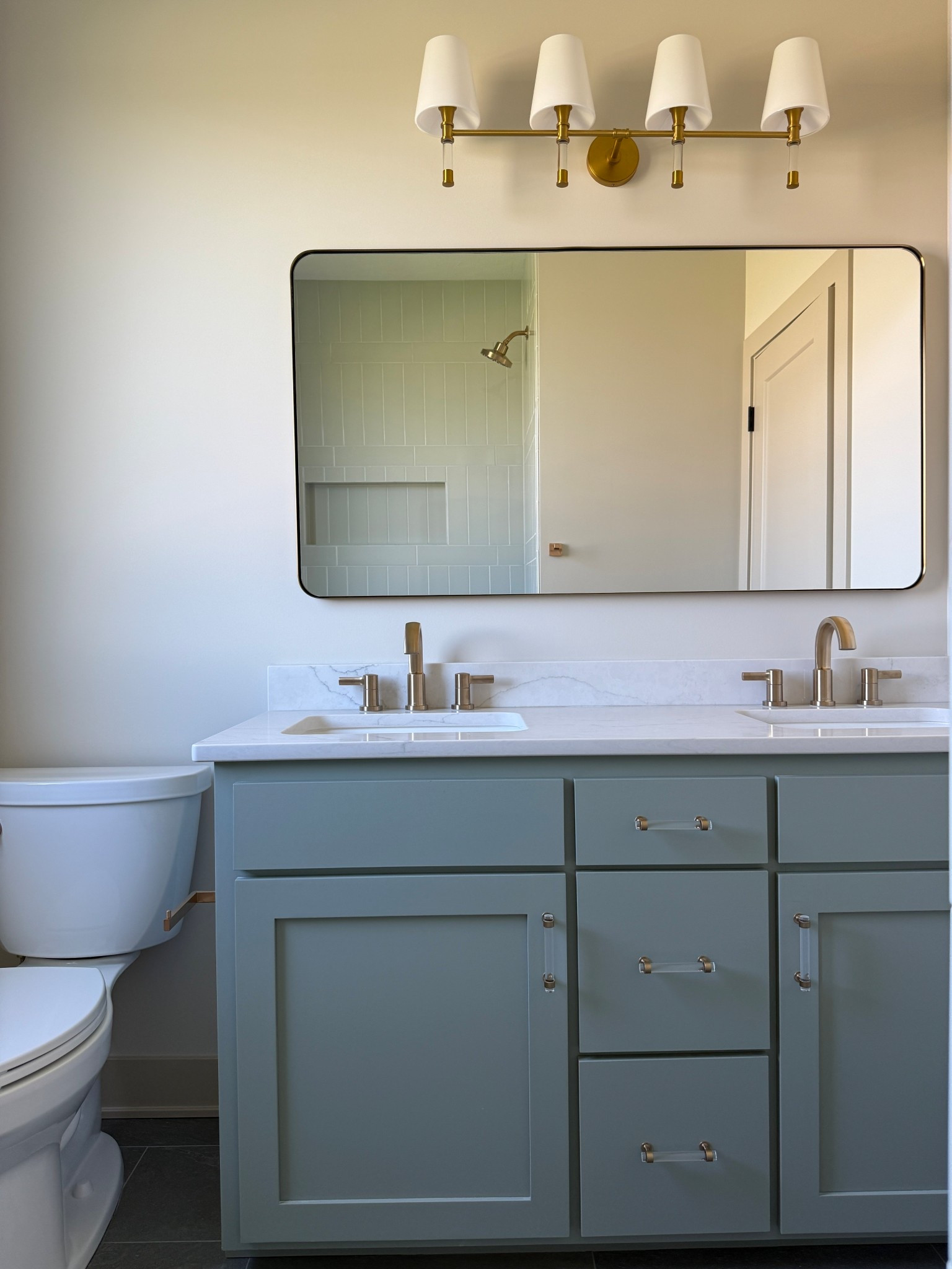 New construction bathroom complete!

Delta faucet 
Visual comfort light
Gold mirror
Acrylic cabinet pull hardware

#LTKStyleTip #LTKFamily #LTKHome