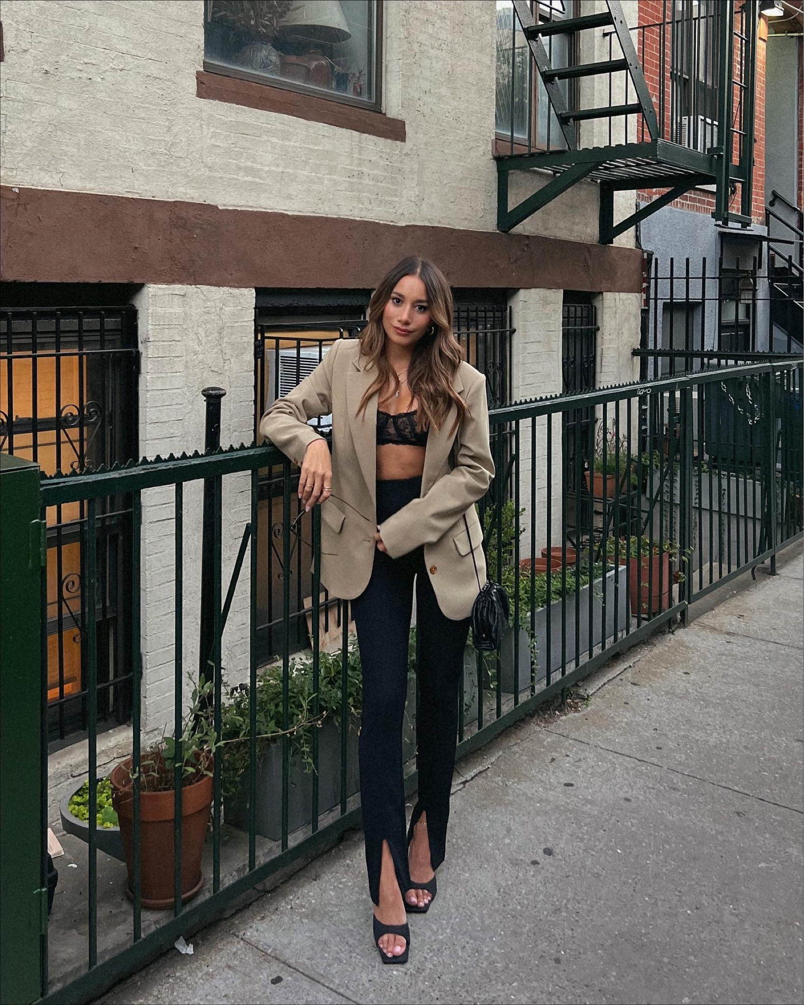 Oversized beige blazer and black slit pants from Revolve styled with balconette bralette for NYFW  


